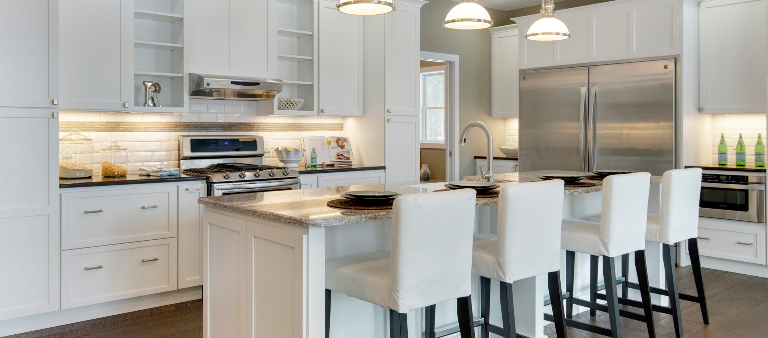 Modern kitchen design with white cabinets and stainless steel hardware