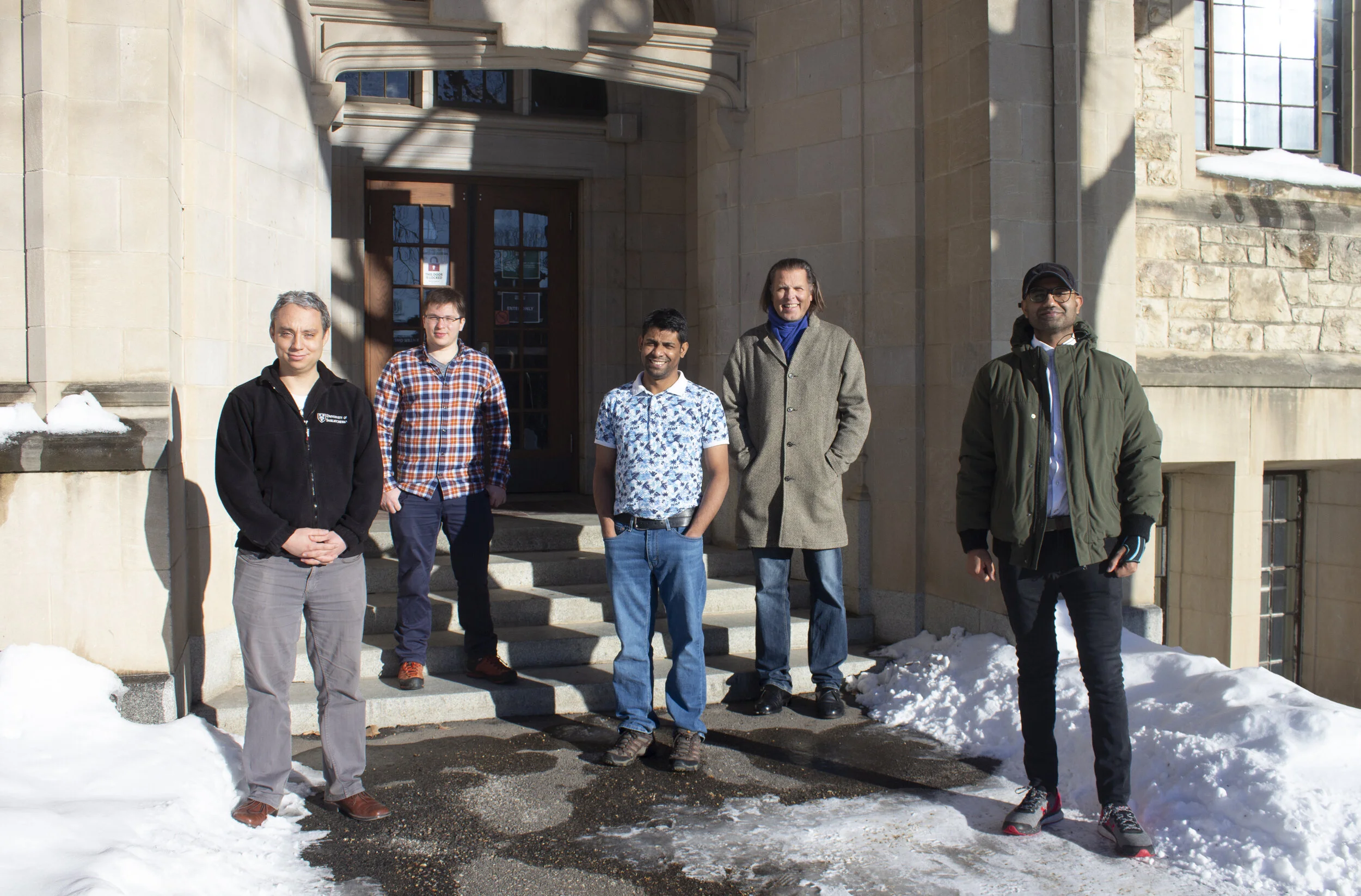 Tristan de Boer, Patrick Braun, Ruhul Amin, Alexander Moewes and Amir Qamar outside the Physics building at USask
