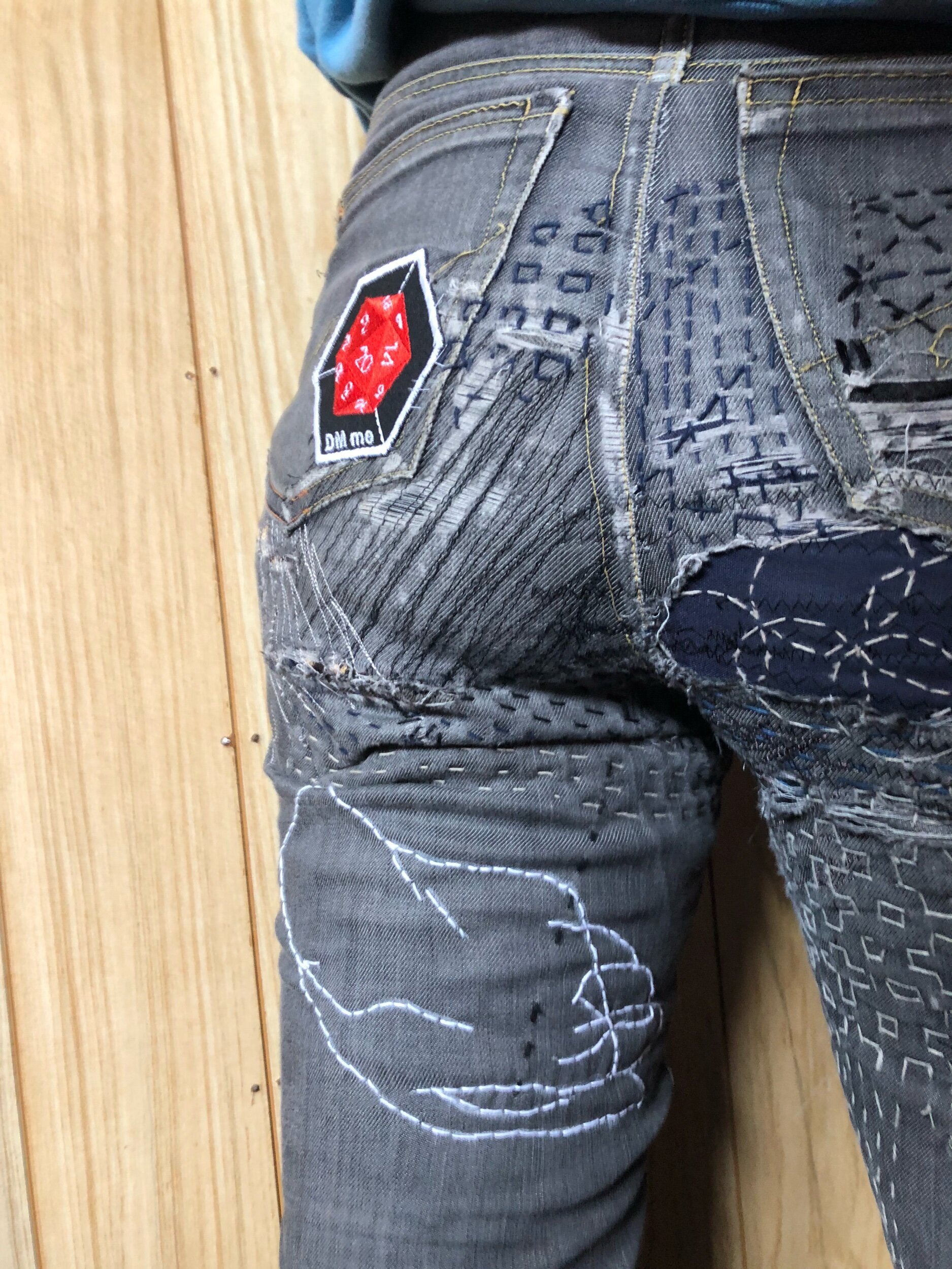 butt view of heavily mended jeans