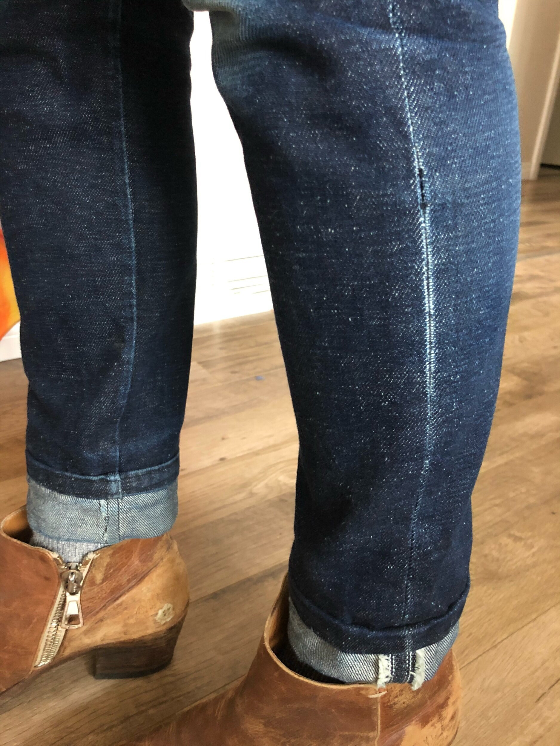 former popped stitches still visible due to jeans aging
