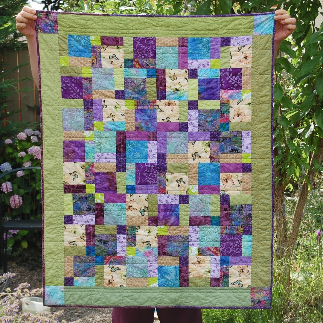 Green Disappearing Nine-Patch Baby Quilt Finished via www.helloquilting.com