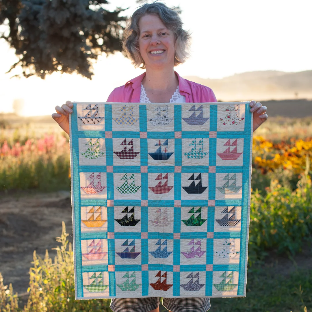 Angela Guzzo from Hello, Quilting! with her Miniature Reproduction Boat Quilt