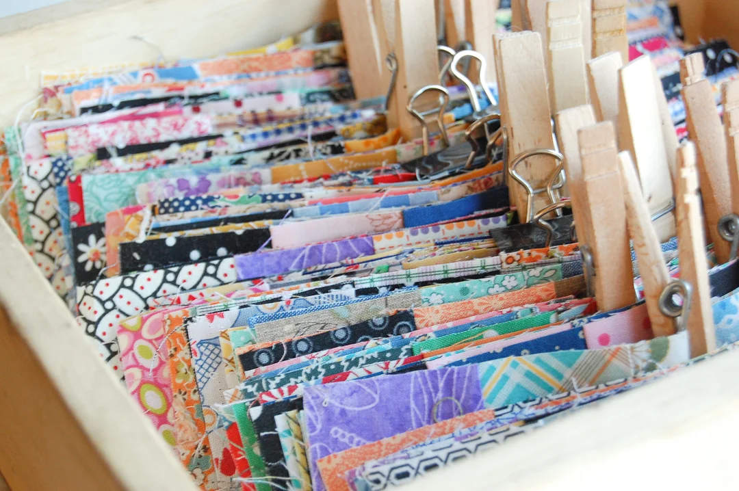 Sorted and Clipped Strip Sets for Scrappy Trip-Around-the-World Quilt via www.helloquilting.com