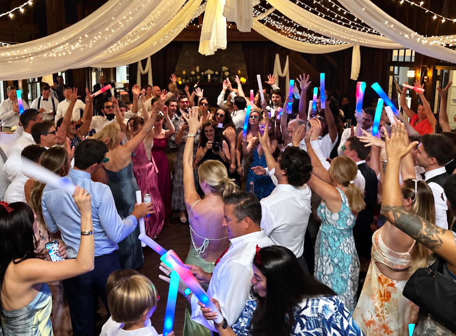 Joyful wedding crowd beneath string lights (1).png