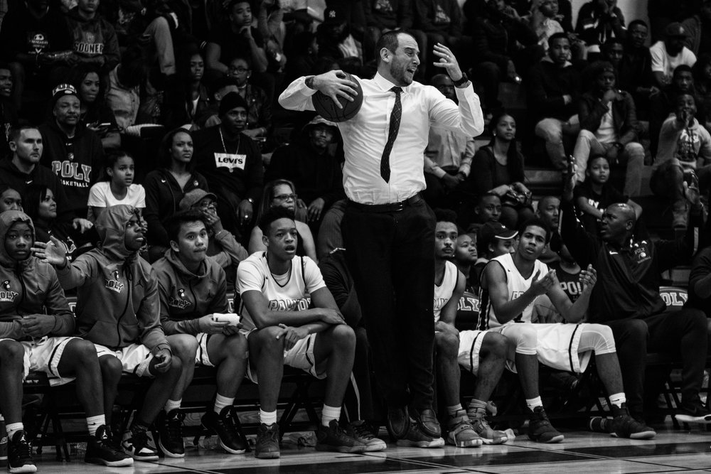 Coach Sam angrily jumps after a questionable call during a game against Chicago's Simeon Academy.  Photo Credit: City Paper, Reginald Thomas II