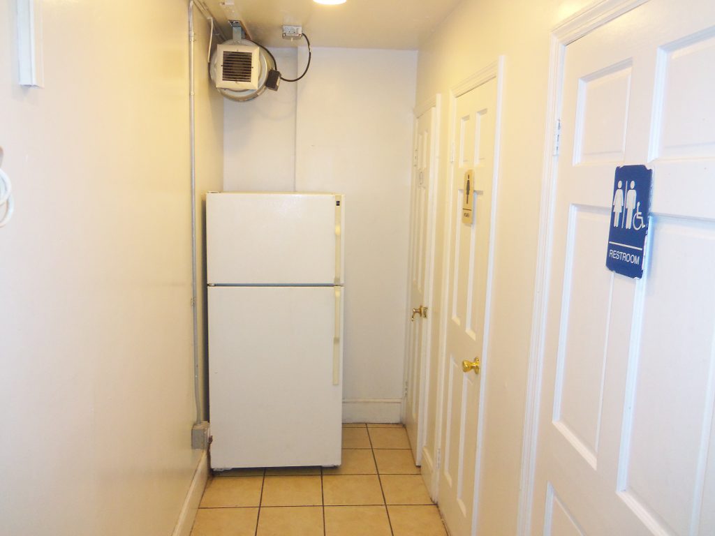 Back Hallway with Refrigerator and Restrooms