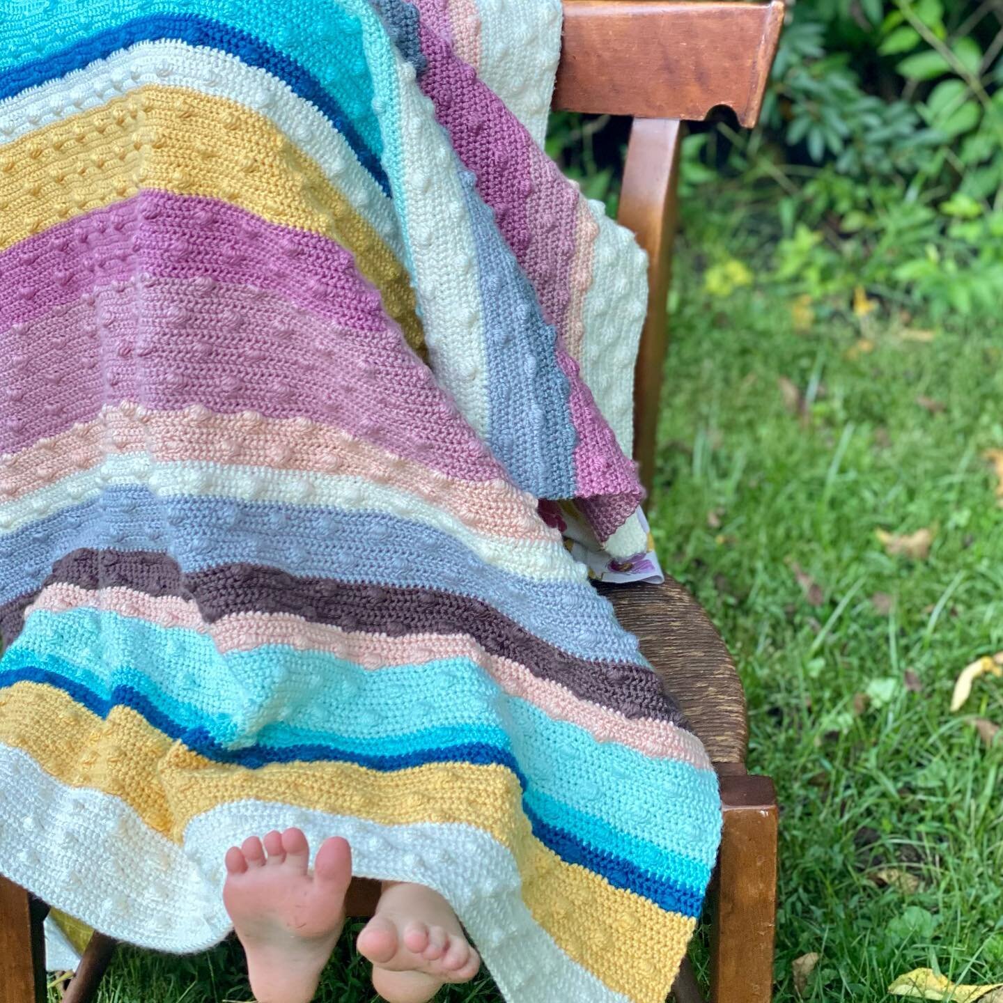 Little toes under the @wild.little.acorn #jaylablanket that I crocheted. My daughter loved snuggling this blanket even while I was still working on it. #yarnspirations #caronsimplysoftyarn