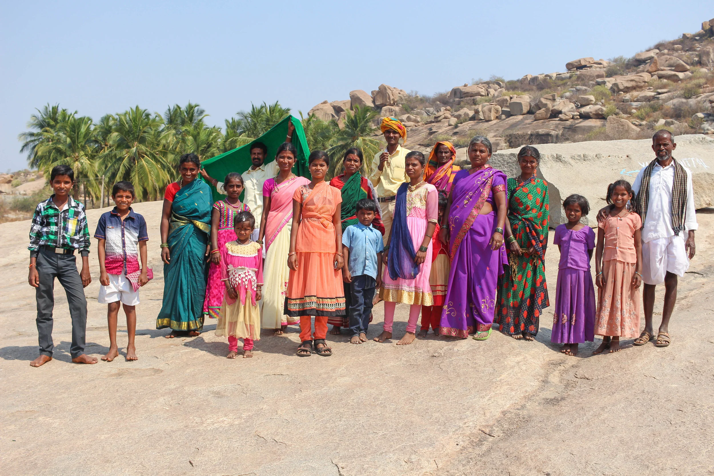 A family visiting Hampi’s temples and making their way to a huge wishing tree nearby