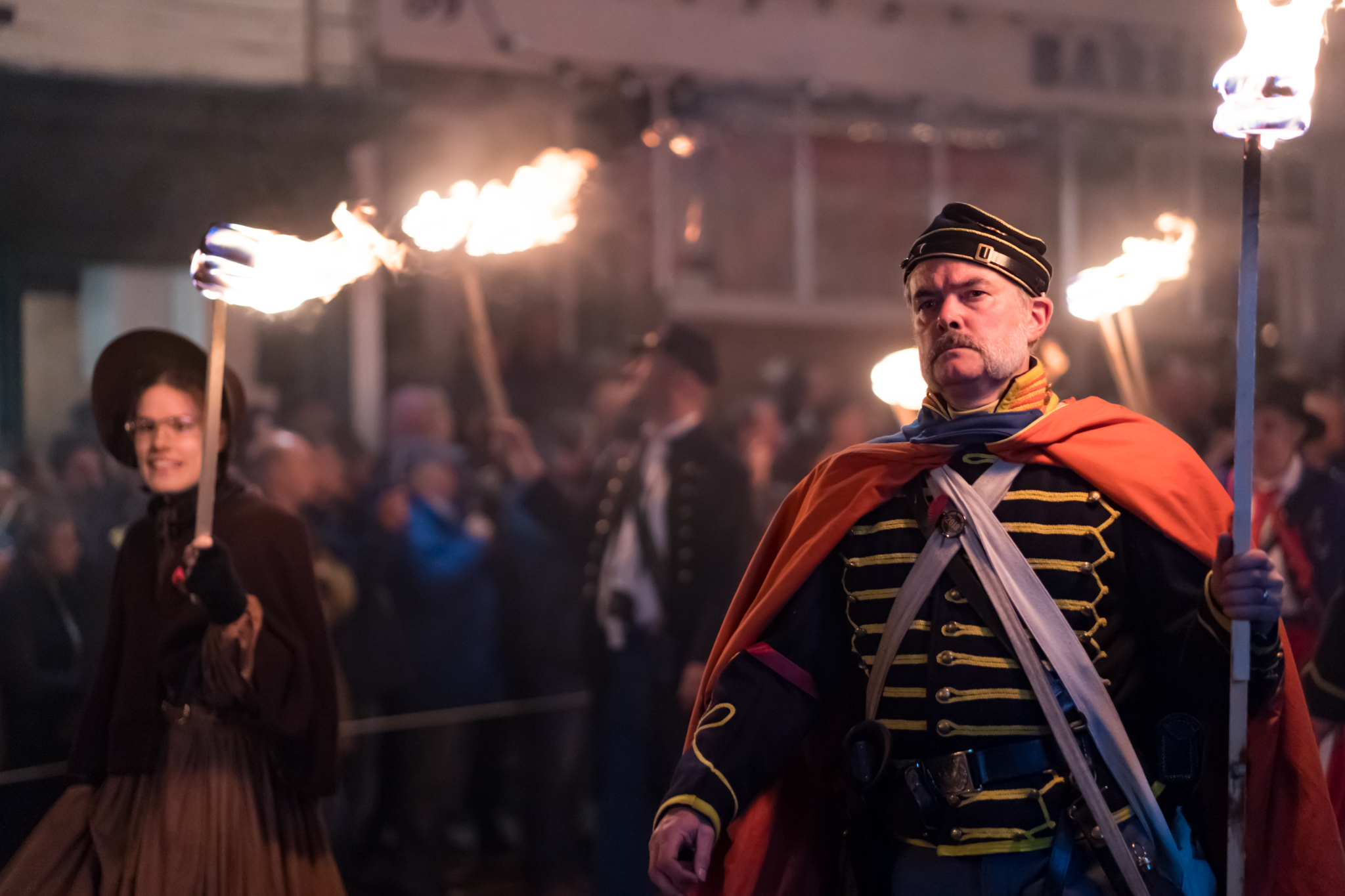 Carrying burning torches through the narrow streets