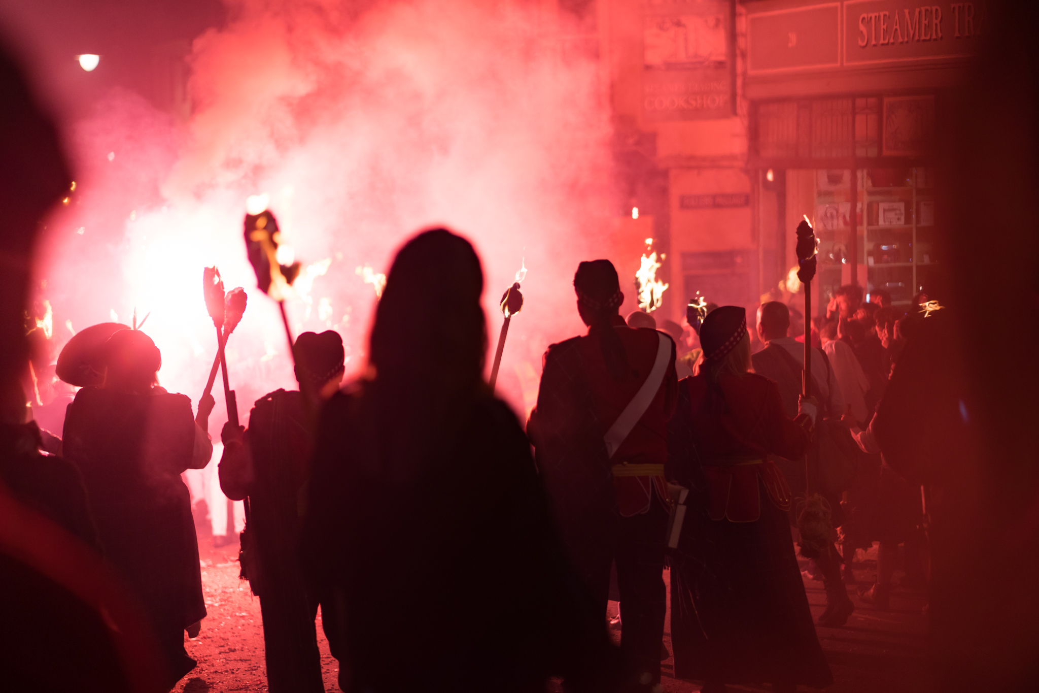 Red flares light up the crowds