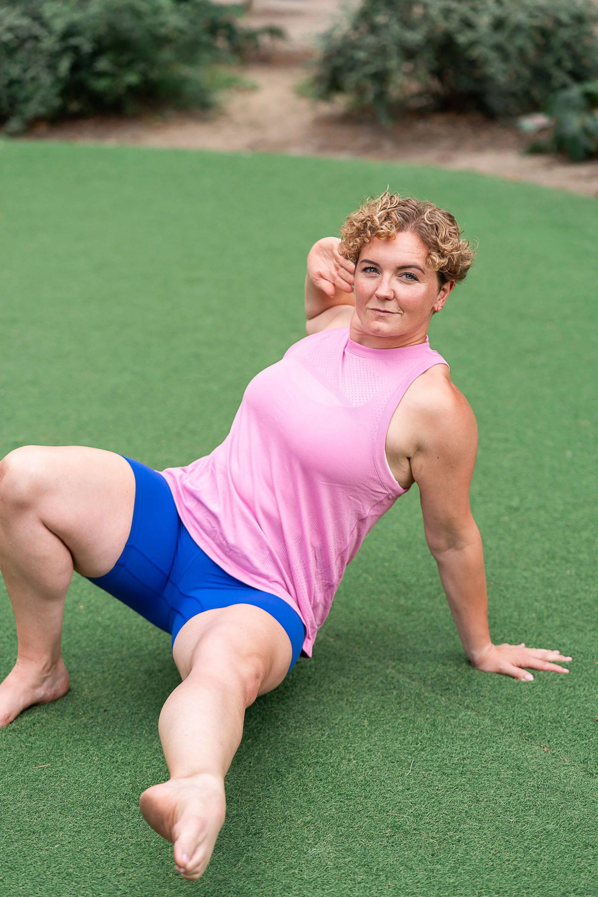 Strength and breathwork coach Rowena Ramsell demonstrating a mobility exercise outdoors