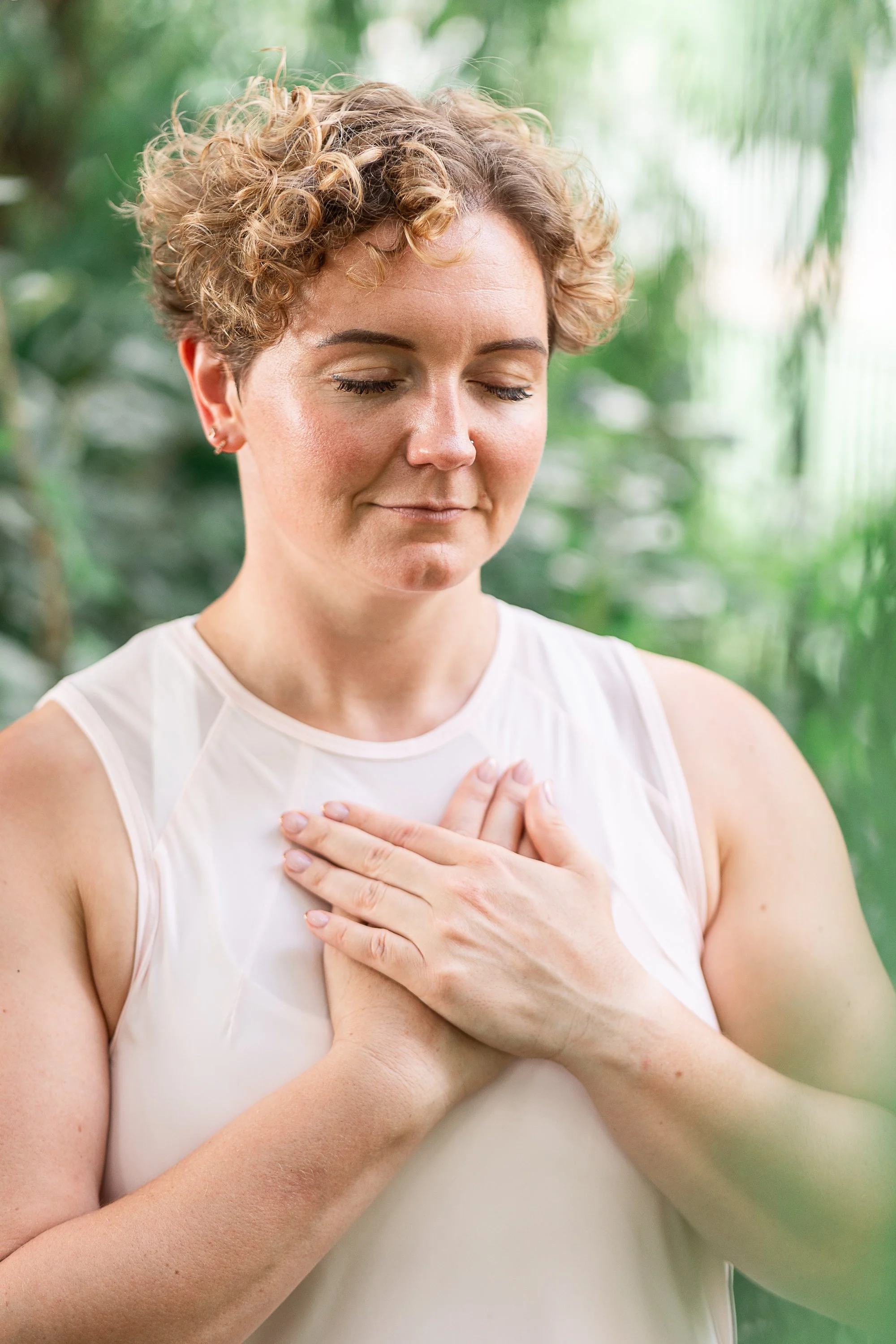 Breathwork coach Rowena Ramsell practising mindful breathing with her hands resting on her chest