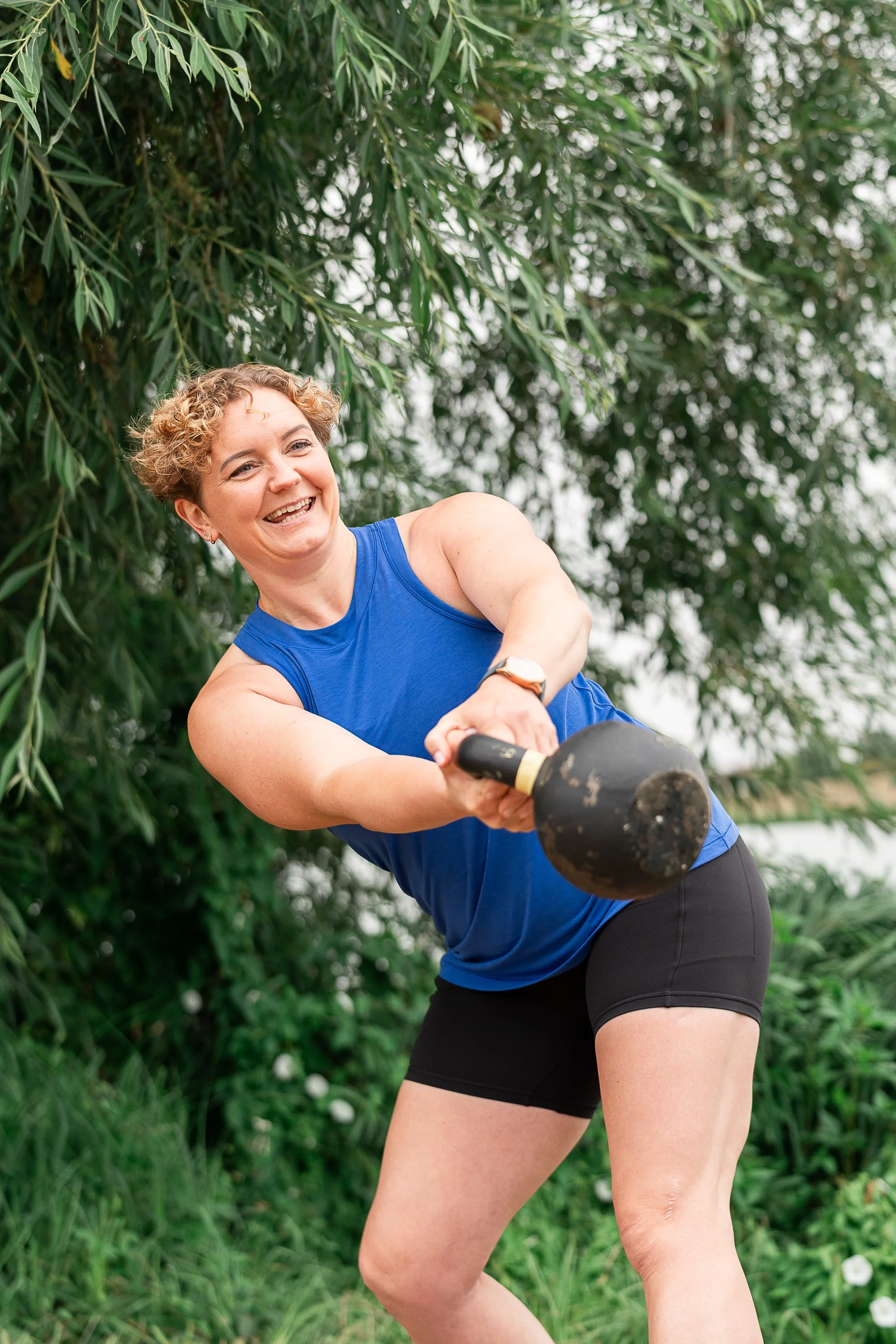 Personal trainer Rowena Ramsell performing a kettlebell exercise outdoors