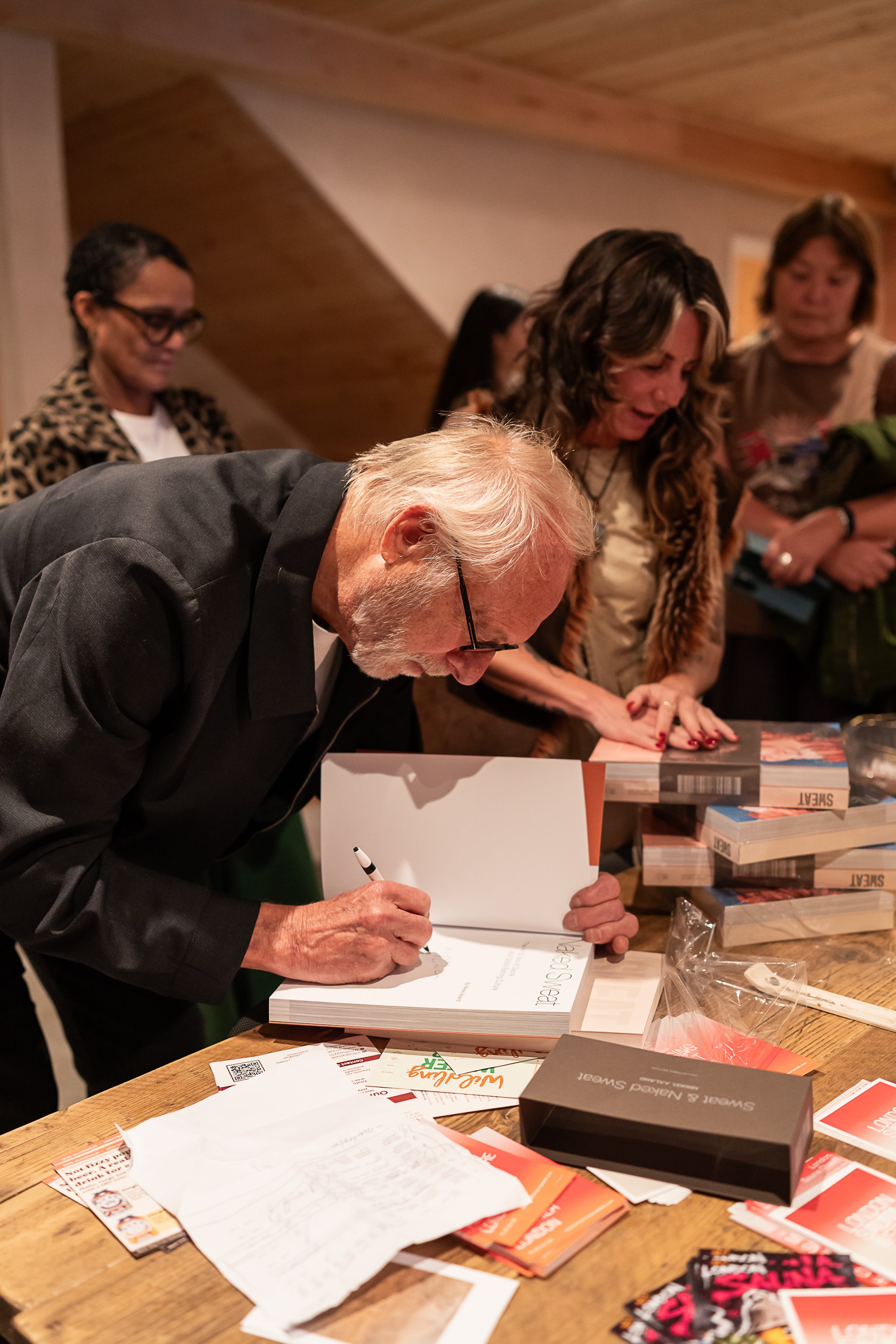 Mikkel Aaland signing a book for a guest at London Sauna Week
