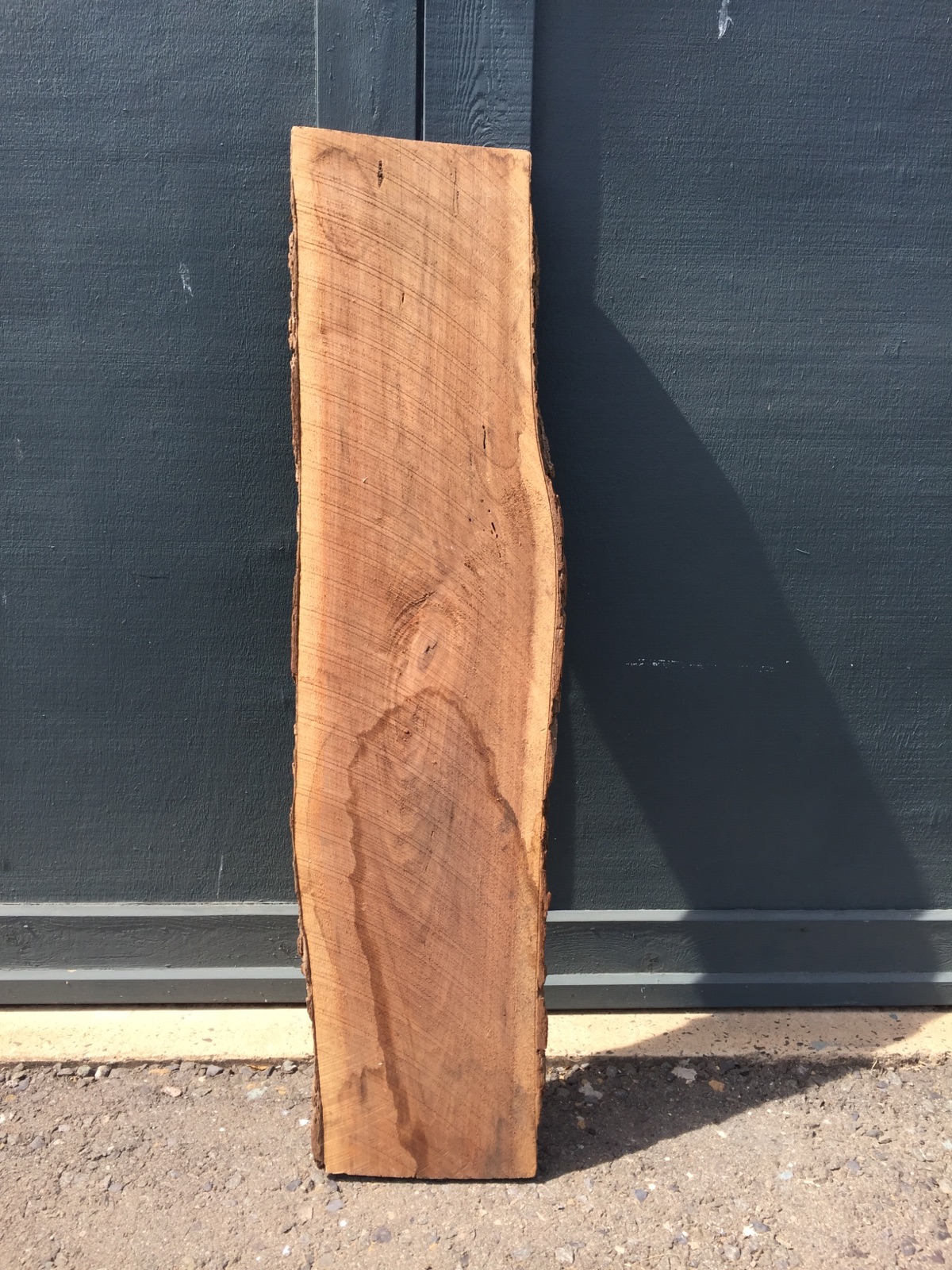 Get a slab of live edge lumber - walnut in this case - with nice character.