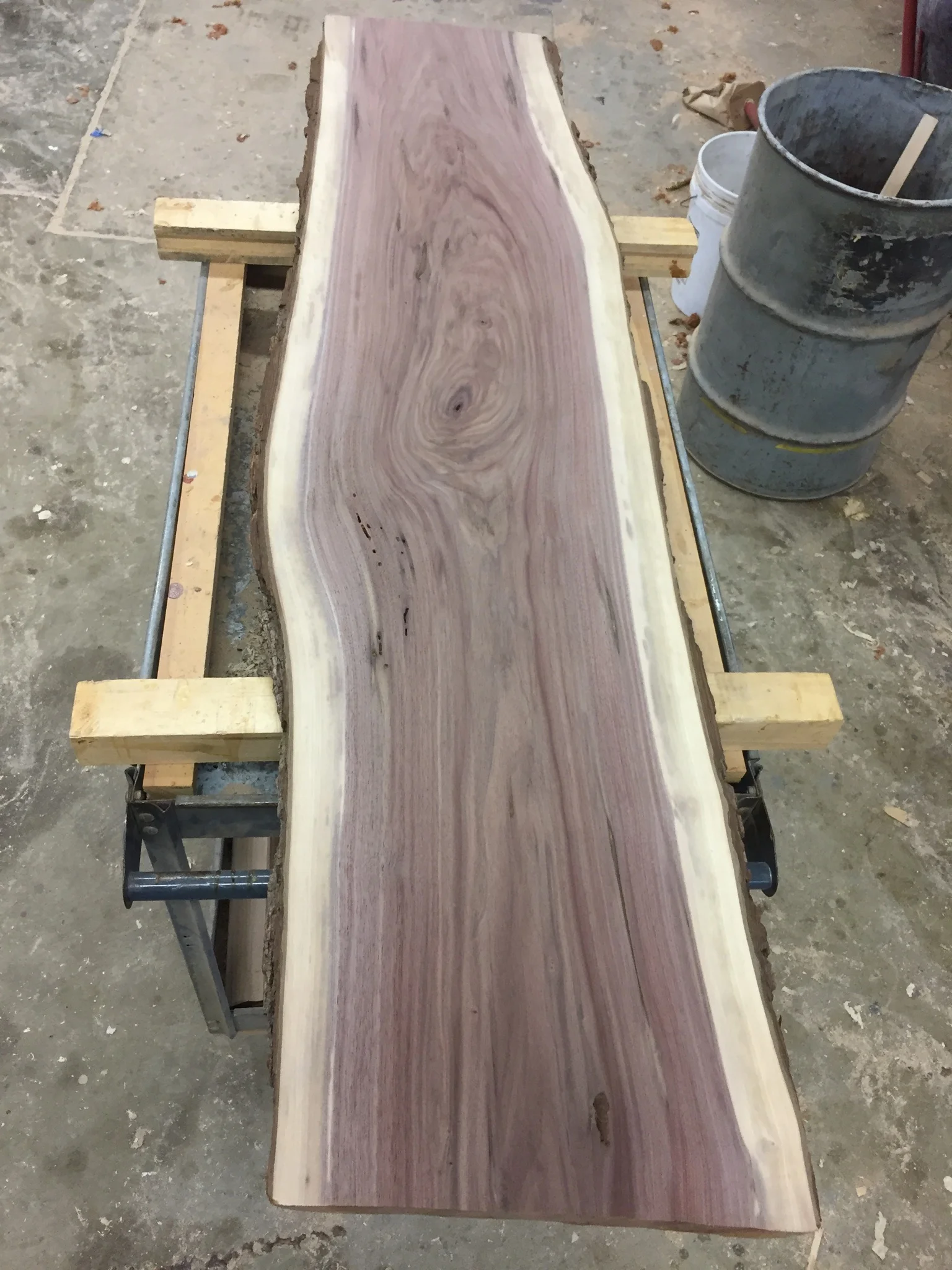 Send it through the wide belt sander to smooth both faces .