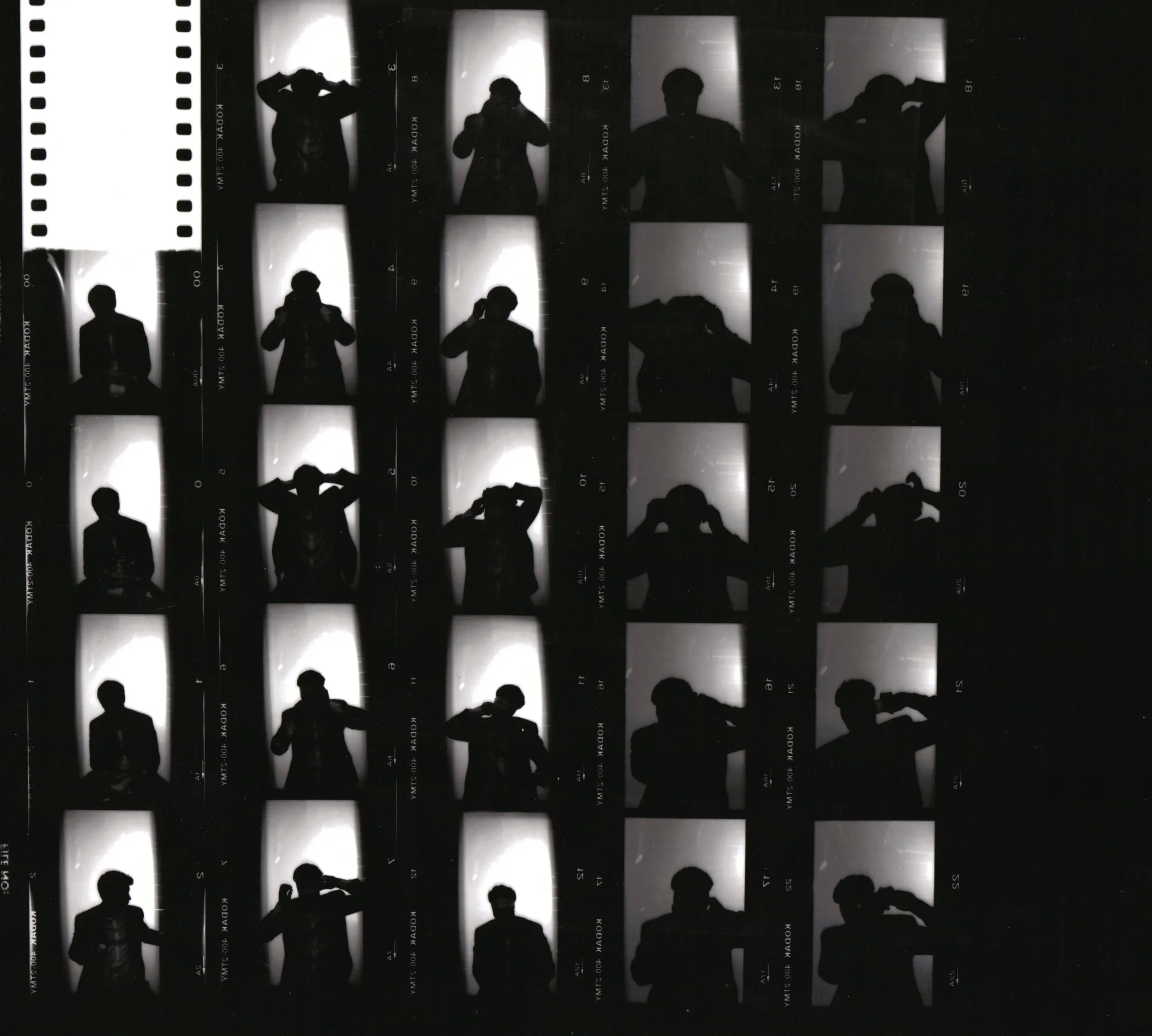 A contact sheet with black and white photo booth images of a person making various poses against a bright background.