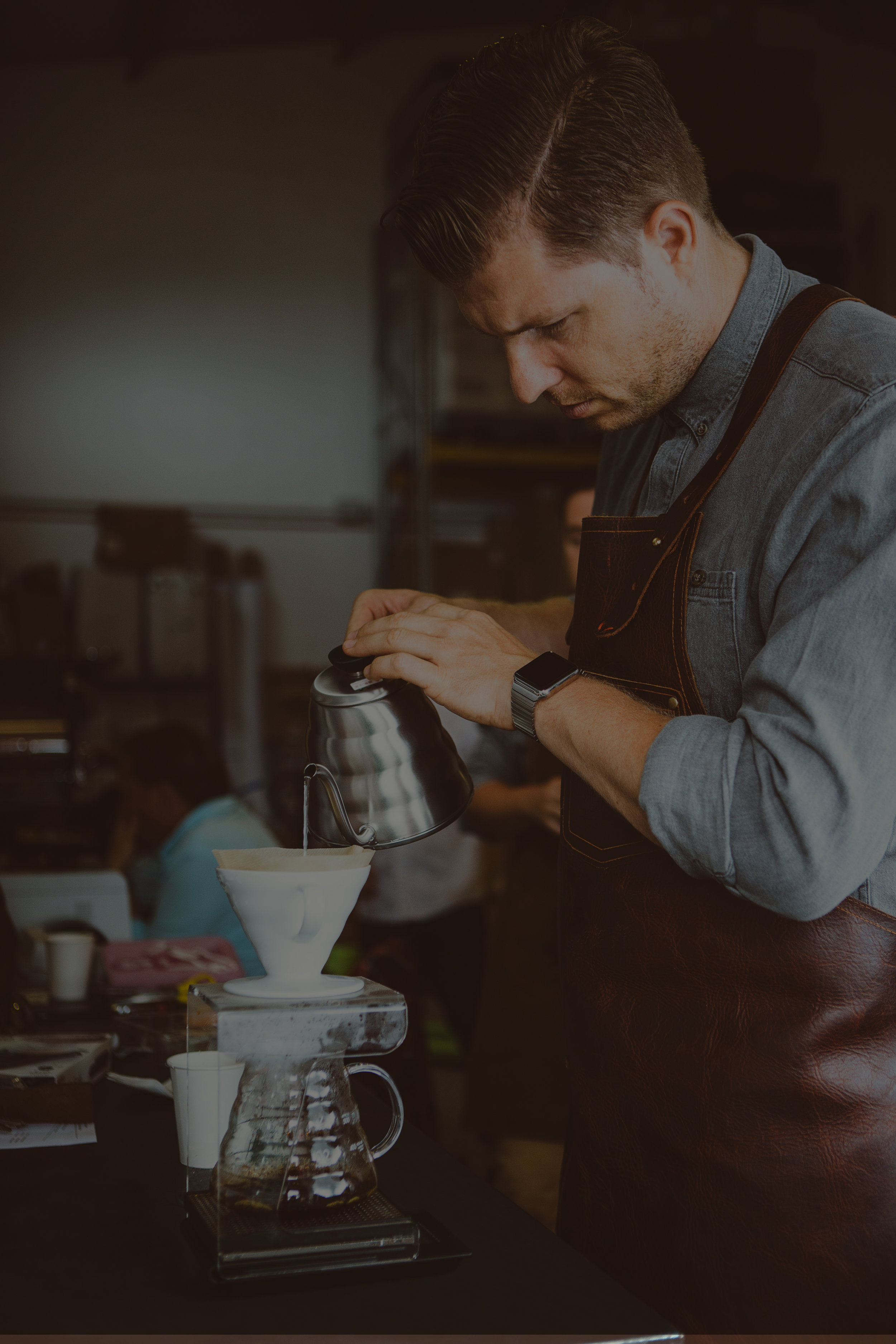 Man pouring hot water in chemex dark.jpg