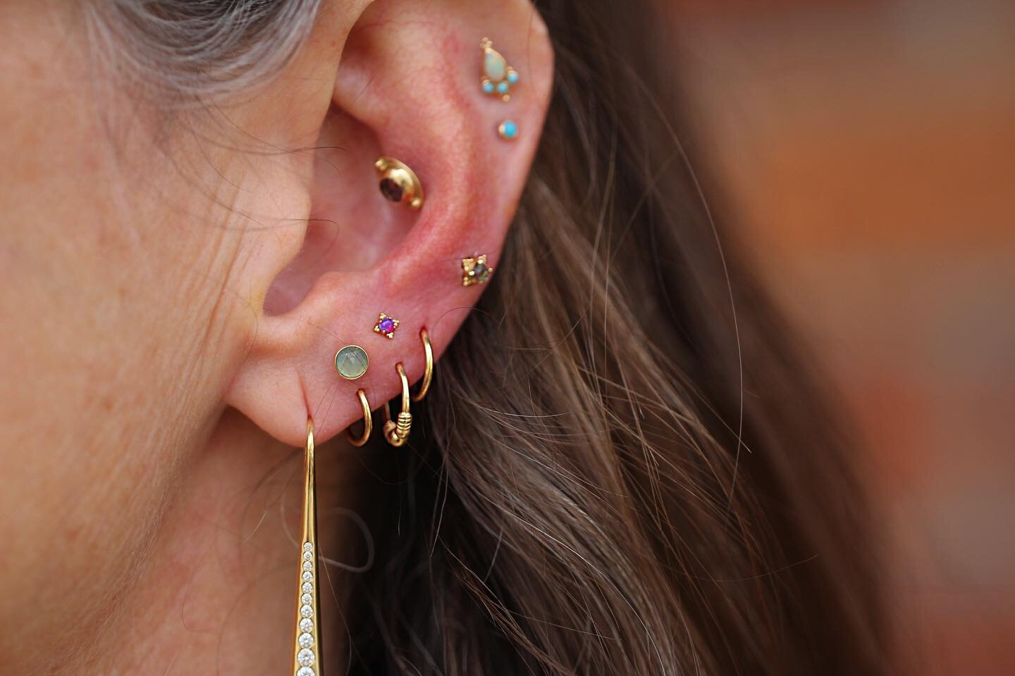 Forever obsessed with @altheasugaree style choice for her ears!  We added an adorable new stack with a Zia in purple opal from @anatometalinc plus more on her other ear!!! Swapped her beautiful chalcedony piece from @bvla to her existing stack as wel