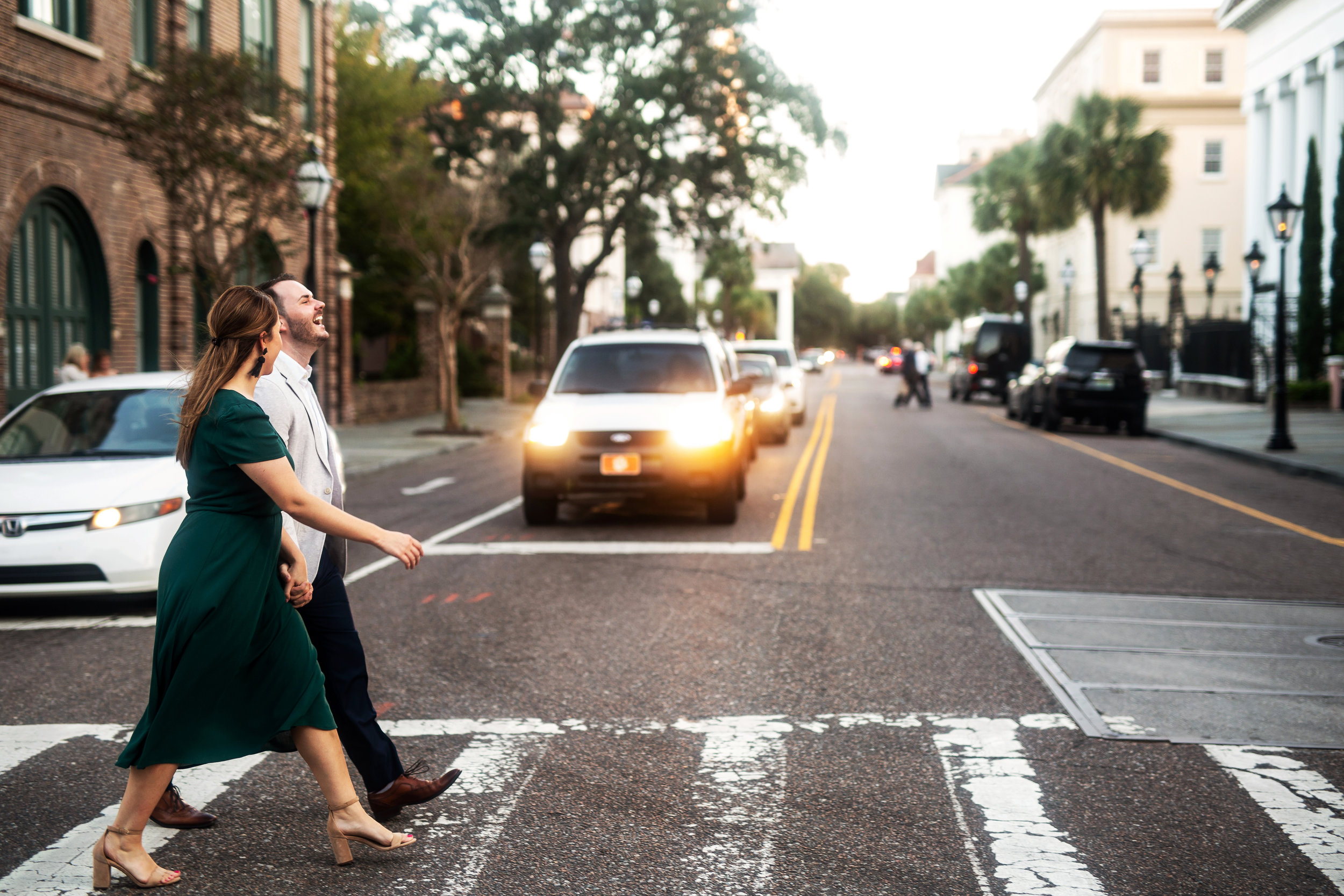 engaged couple crosses street