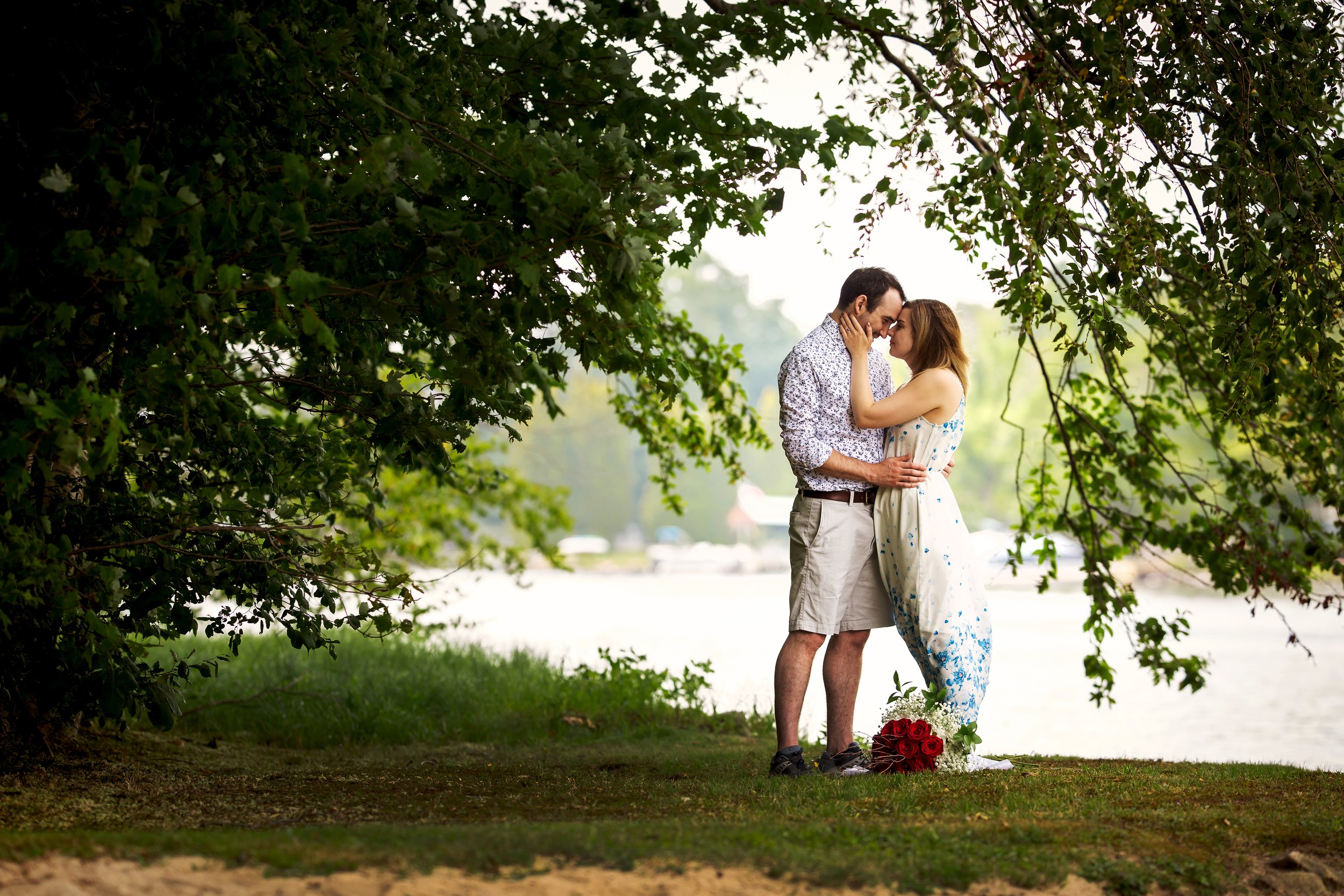newly engaged couple by lake