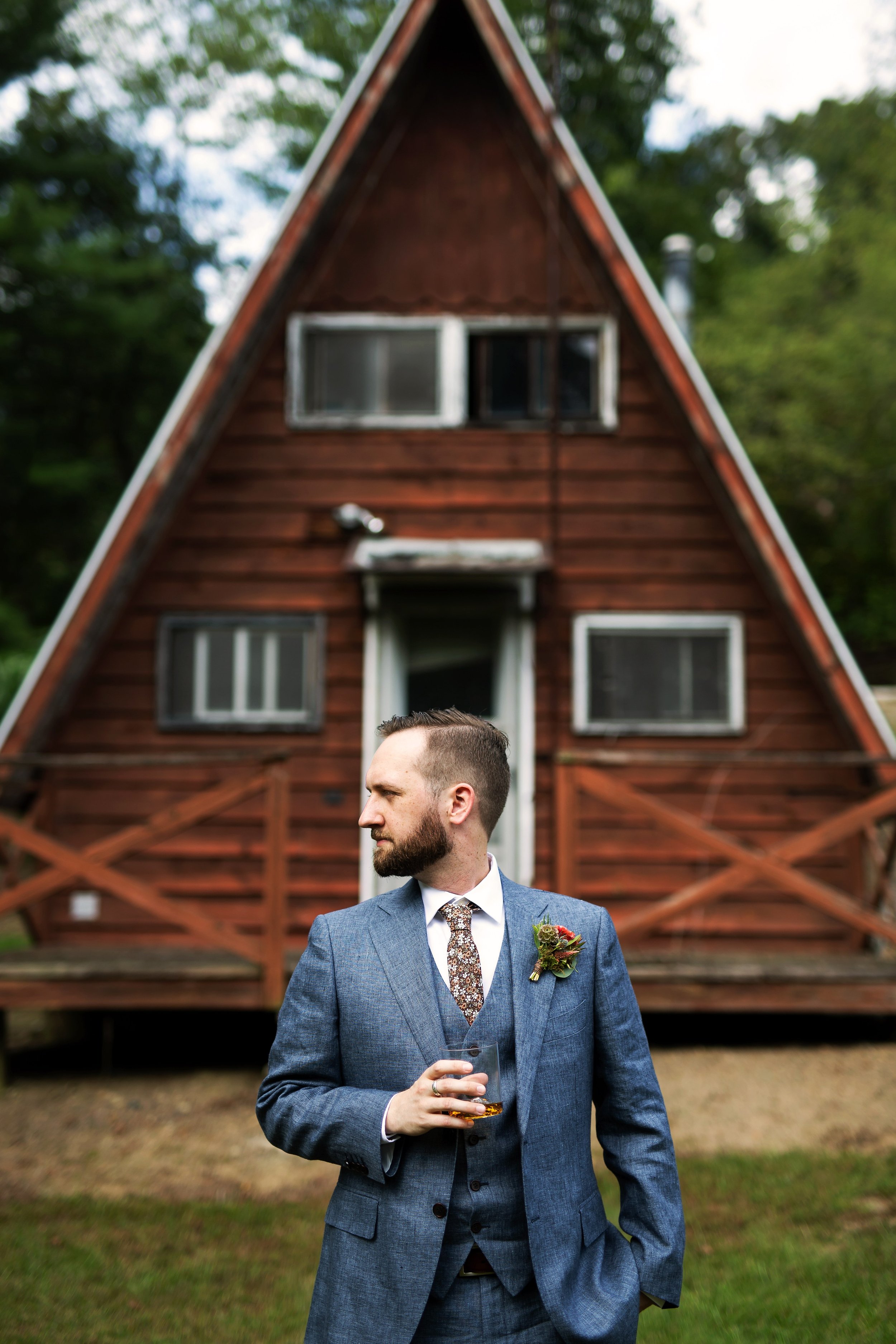 Groom poses with whiskey