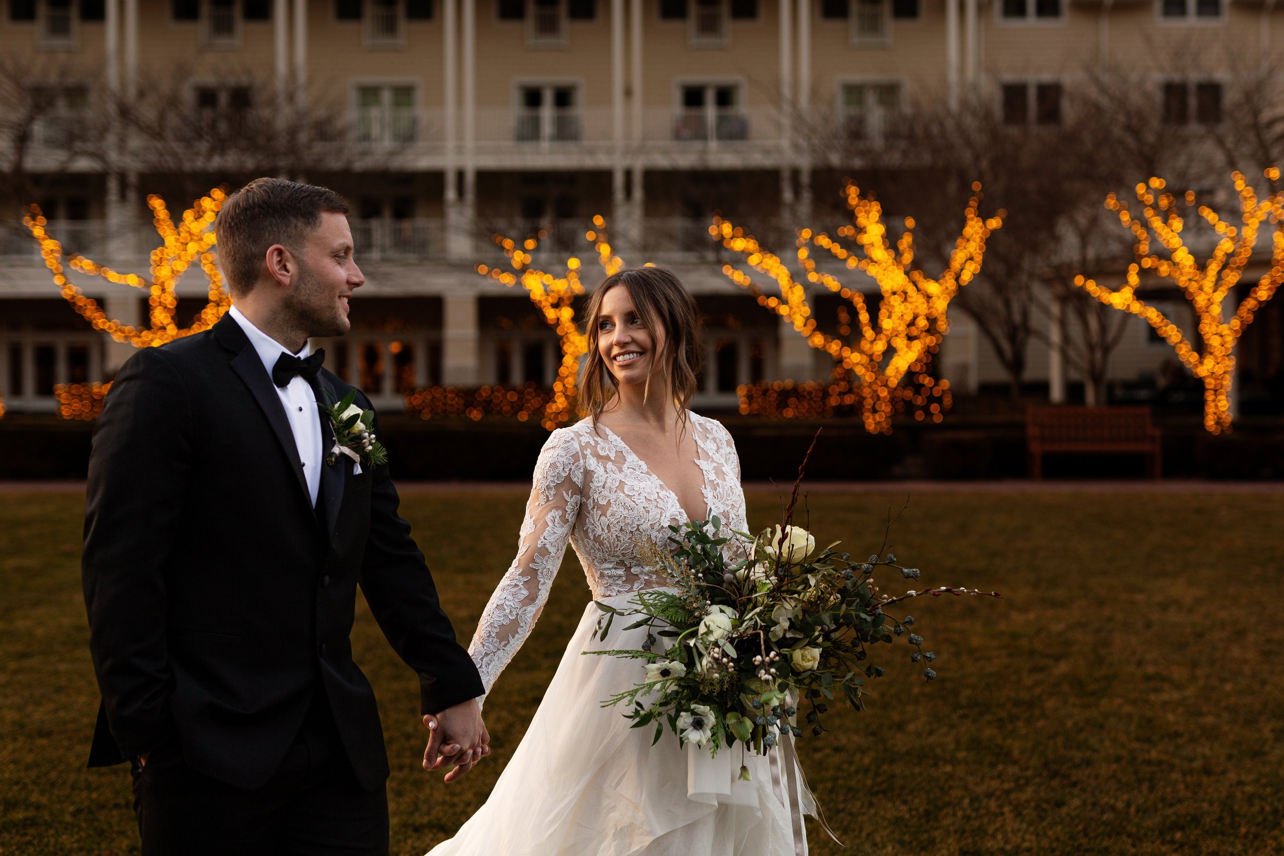 couple walk string lights