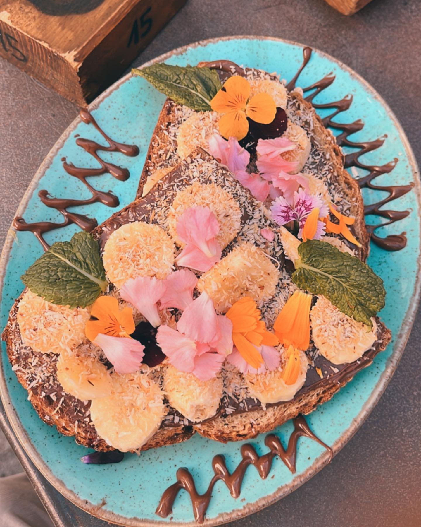 Our Nutter Butter Toast. Sour dough bread, a thick layer of almond butter, sliced banana, toasted coconut, chocolate syrup and of course our signature edible and organic flowers.

Special note&hellip;. This can also be made with Nutella if you ask wh