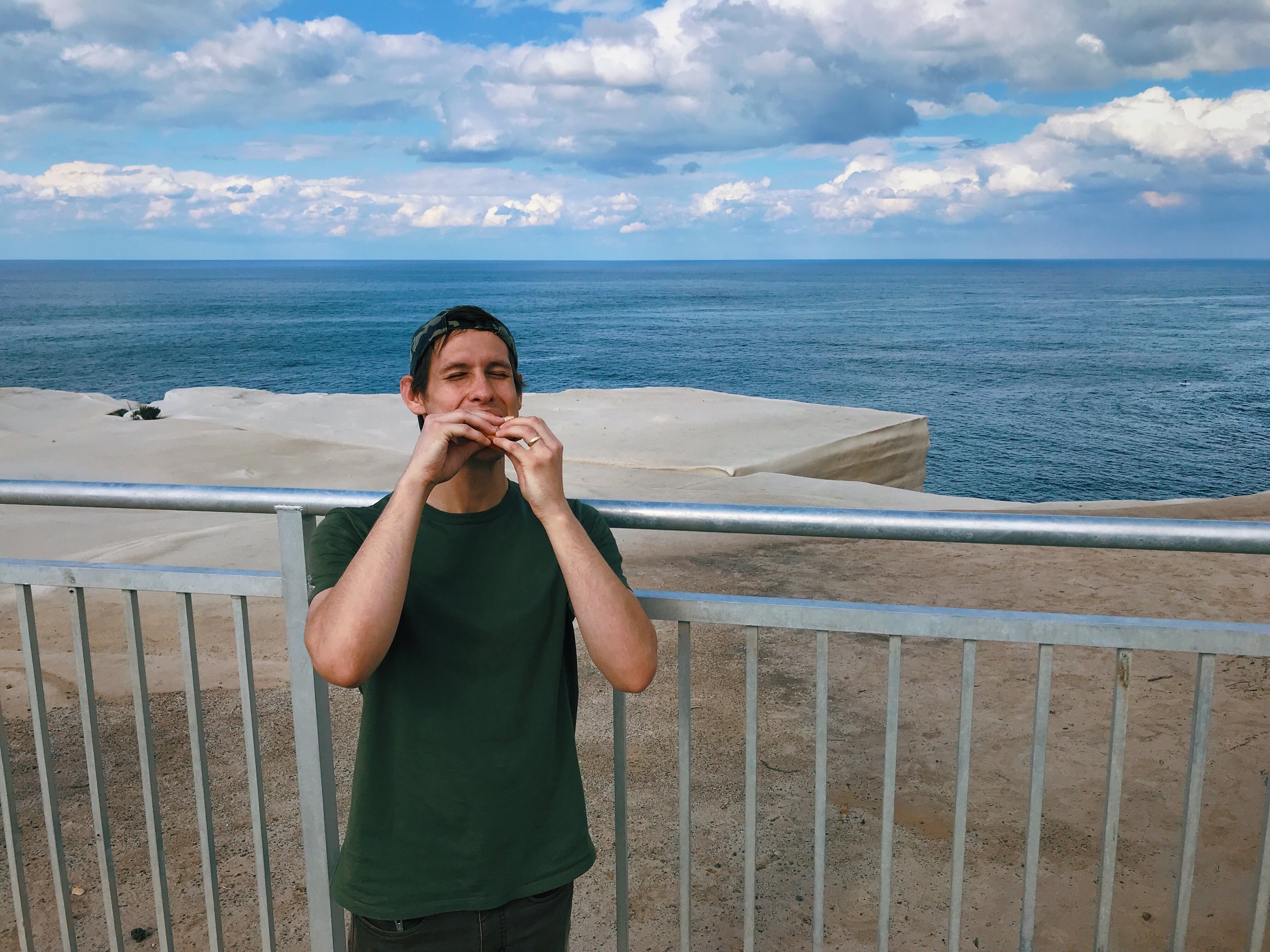 Tyler eating cake at Wedding Cake Rock, so named because it looks like a wedding cake. It is now fenced off because it’s unstable + dangerous, but has been a popular photo op and daring hikers were still risking it for the gram.