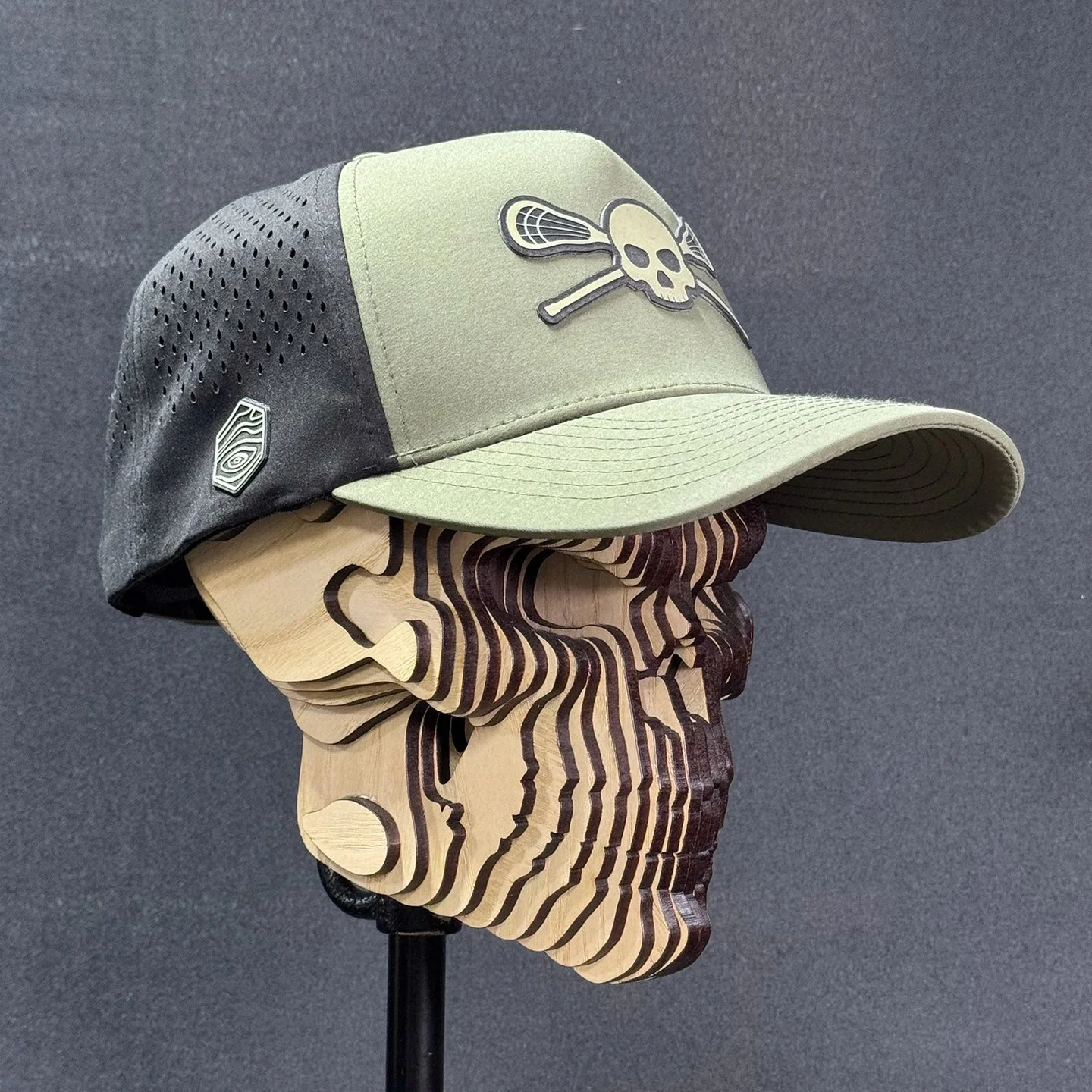 For the players, coaches, and sideline regulars. 🥍

Introducing the Skull &amp; Sticks Lacrosse Hat.

Loden/black snapback. Laser-engraved silicone patch. Made to order at Beezlee Creations.

Available now&mdash;shop through the link in our bio.

#L