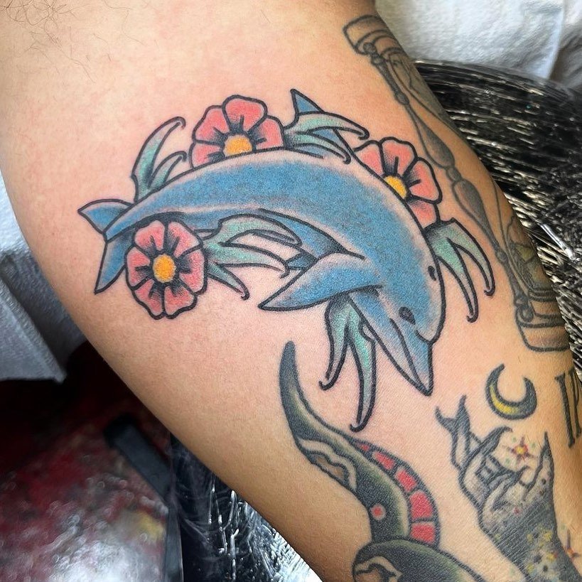 Over the knee jumping dolphin tattoo by Deborah Pow  Tattoogridnet