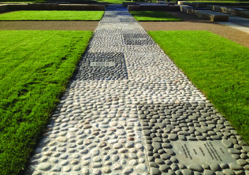 The role of Lead Artist produced a variety of specific features as well as an overall input into layout and palette. Most notable is the cobble path which acts as a time-line detailing Benedict Biscop's six journeys to Rome in the late 7th Century, running along the archaeological site of the original feature. These are cast aluminium panels set amongst real cobbles.