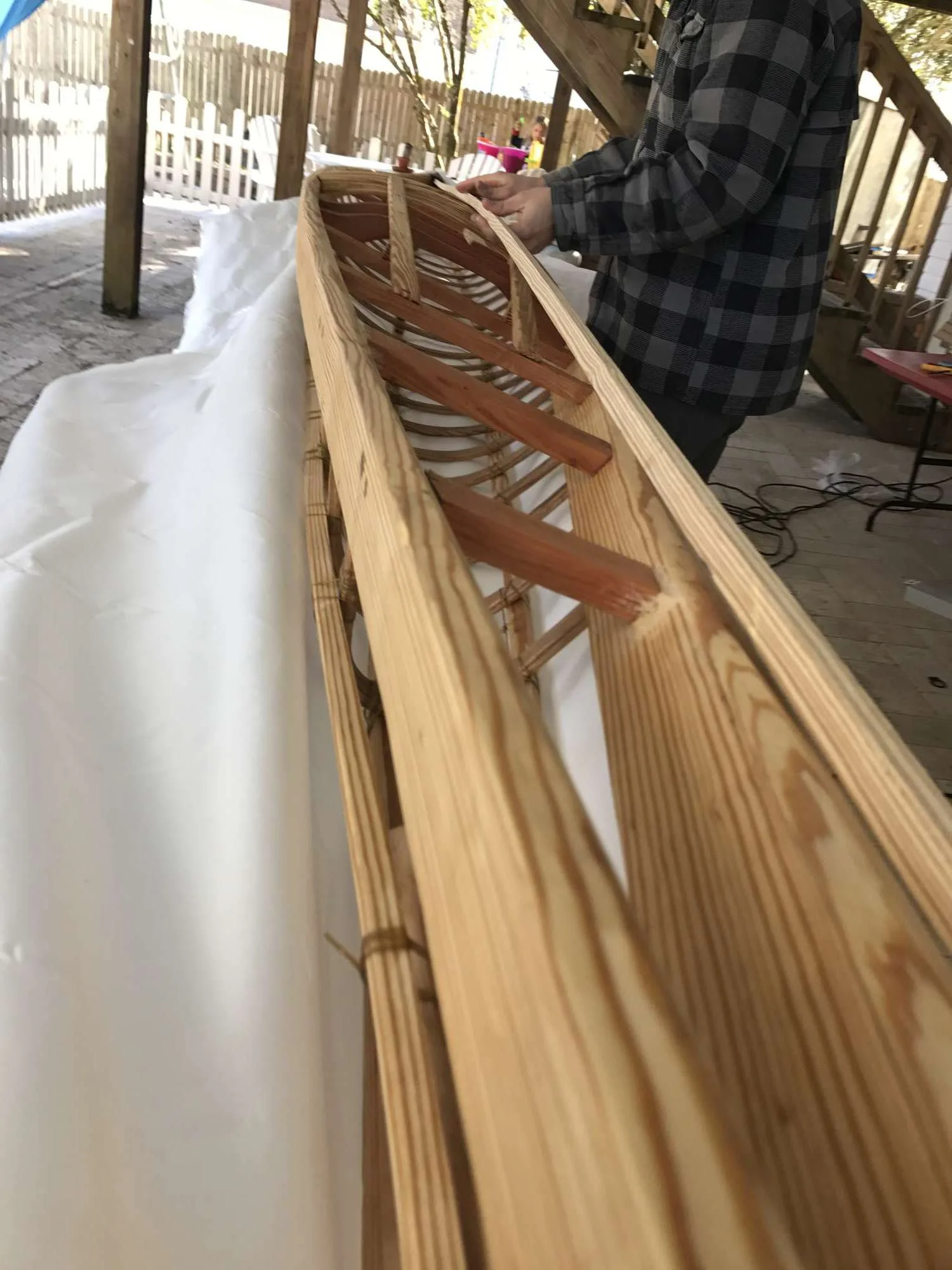 Temporarily marking the center line of the kayak with a board so the fabric can be cut to size. 