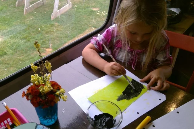 Black paint over yellow crayon creates a “scratch and see” picture of the night sky!