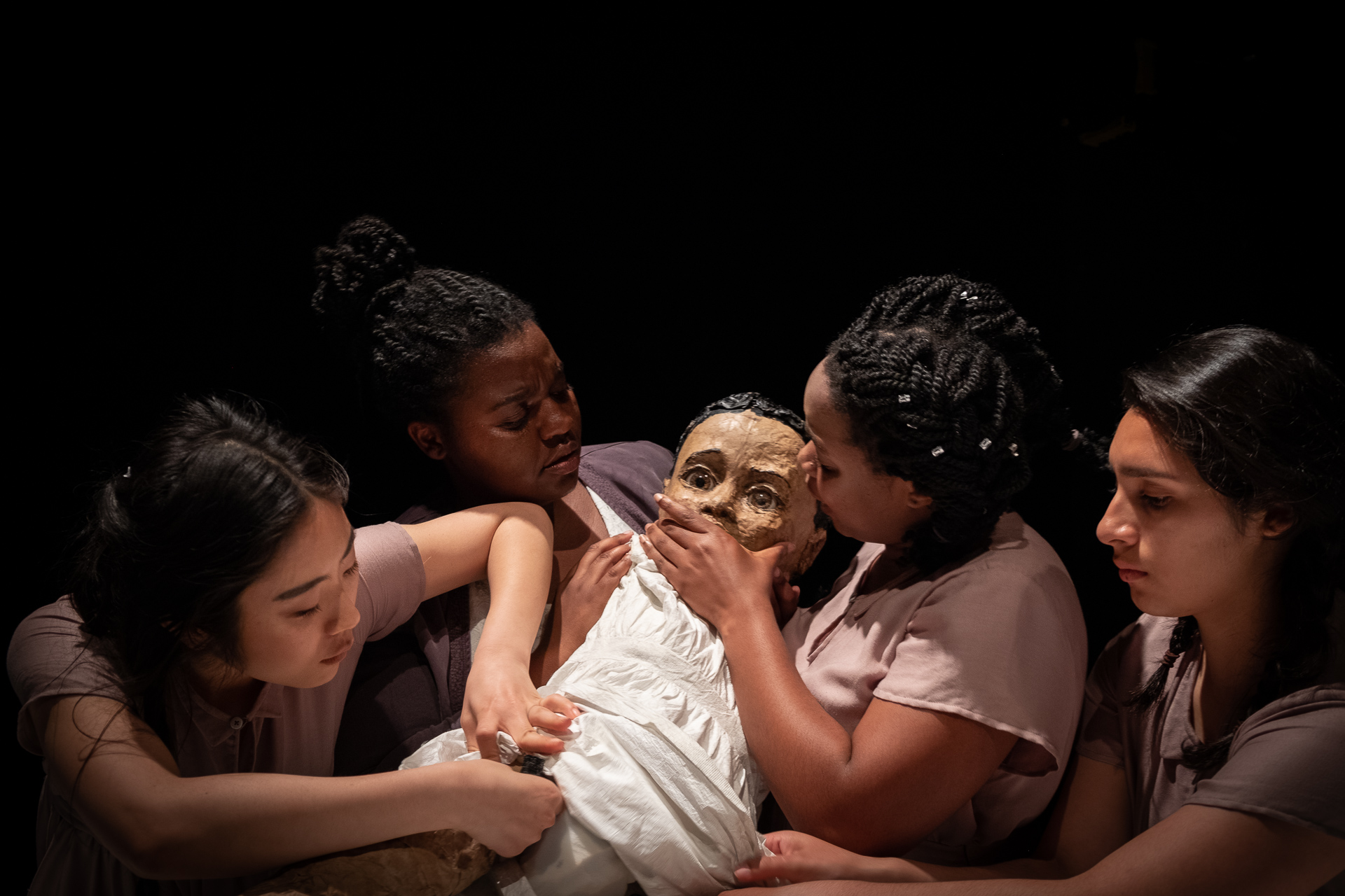 The puppetry highlights the formation and fragility of self. It forms a layer of meaning, literally building the self as it it is held and supported (or not supported) by a community at large.