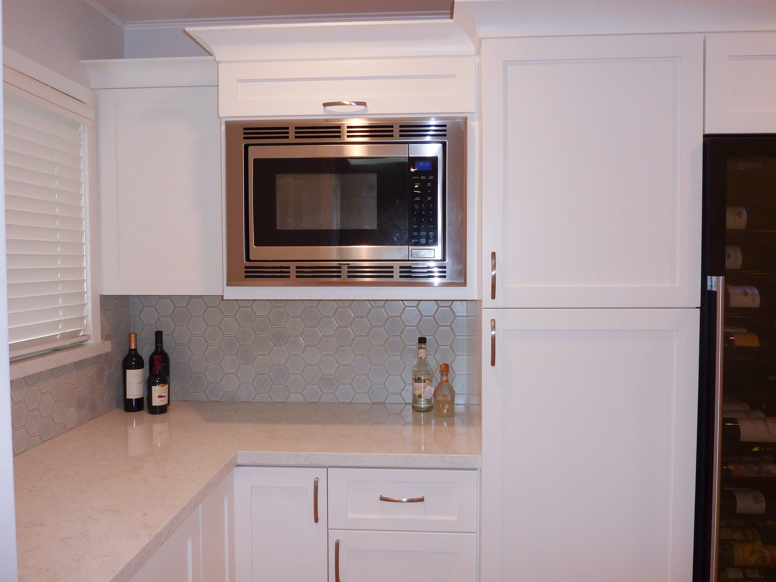 A closer look at the built-in microwave in the walk-in pantry.
