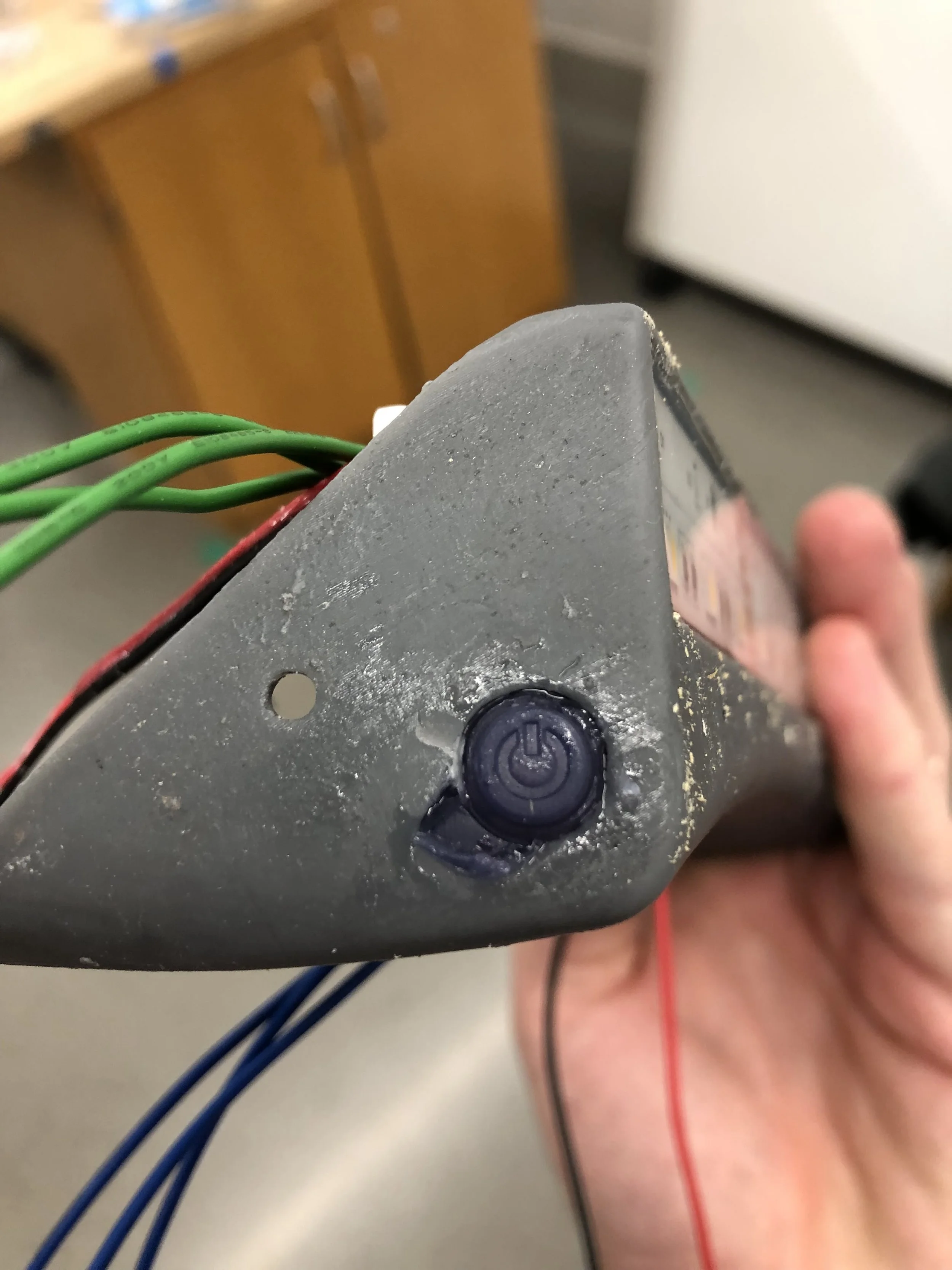 WE HAVE A BUTTON! A small section of the enclosure was accidentally chipped off while removing some of the support material that was blocking the button cavity