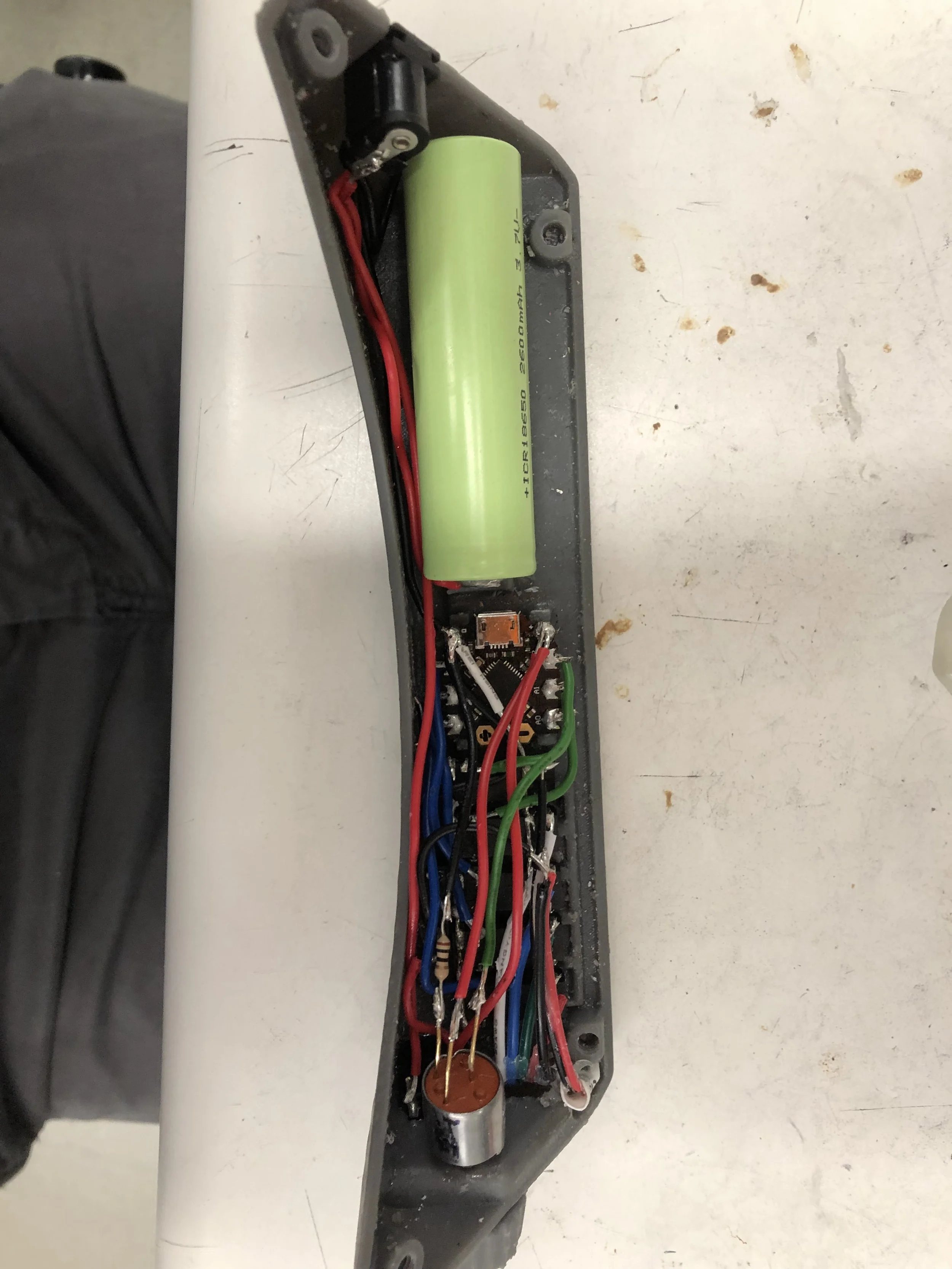 With wire lengths trimmed and the board accidentally shorted, the white light turns on and the assembly is ready to be enclosed and potted