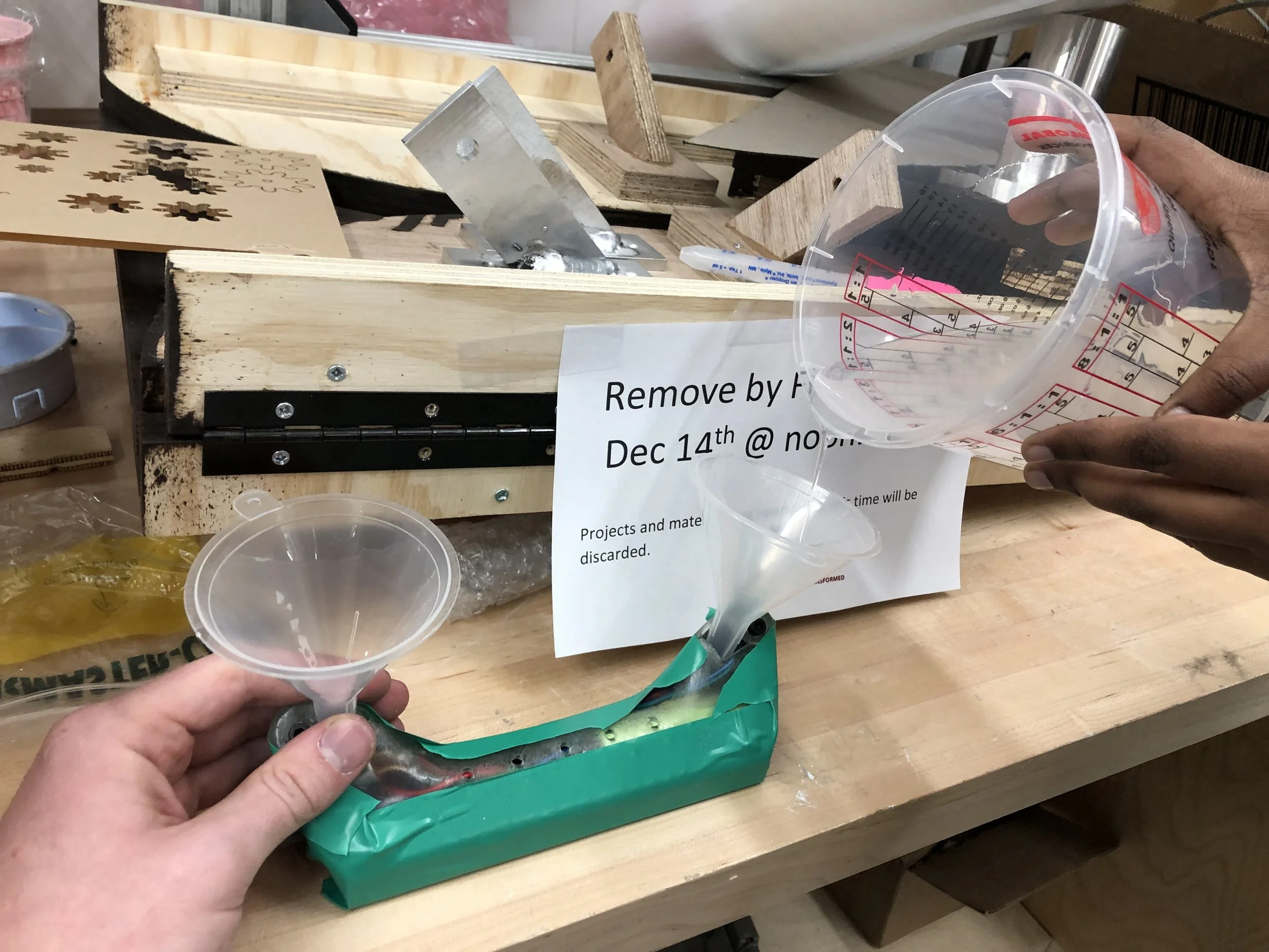 And the resin is poured! After the resin just reaches the weep holes (so we don’t trap any air bubbles) we covered them with tape and filled the rest of the enclosure. The entire assembly was placed into a 90psi pressure pot to force any bubbles i