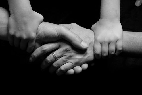 Black and white image of linked hands