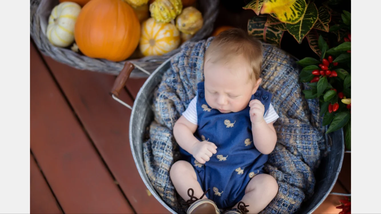 Newborn little Patrick in his lion romper from Janie and Jack