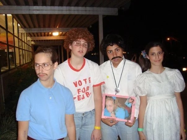 I'm on the left, dressed as Kip, Napoleon Dynamite's brother. For our costume dance that year, my friends and I knew we could pull off this look well. We even danced in character that night. When this picture was first posted on Facebook, someone who didn't know me wrote in the comments, "Wow that kid looks exactly like Kip," implying that he didn't know if that "kid" was a guy or a girl. Success.