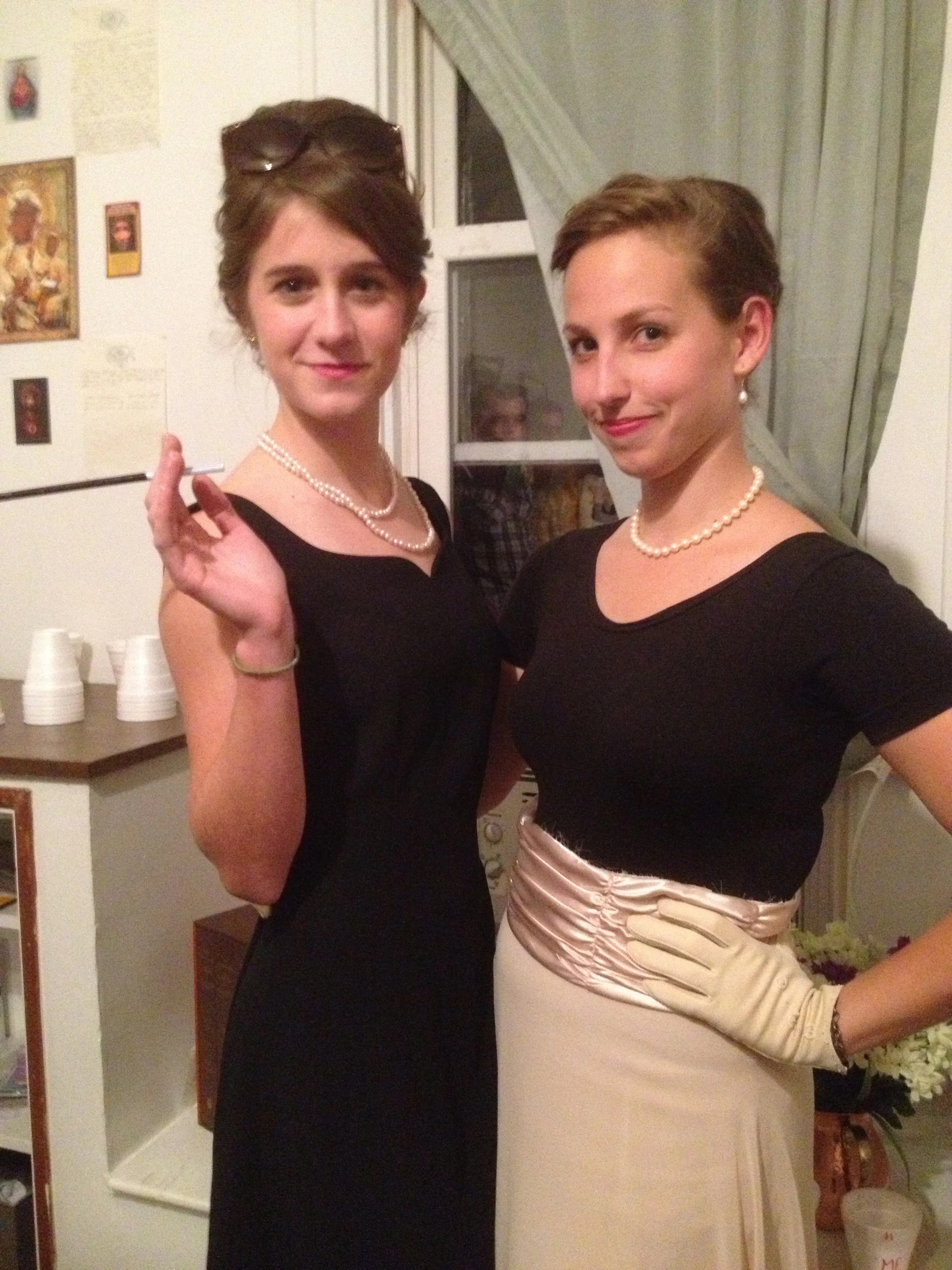 This is my friend Sarah and me. Almost every part of our entire Audrey Hepburn and Grace Kelly outfits were from thrift stores. I'm wearing Sarah's black leotard, but my skirt is the bottom half of a dress that I cut to look like a famous Grace Kelly picture. The creepy men in the window are not from a thrift store.