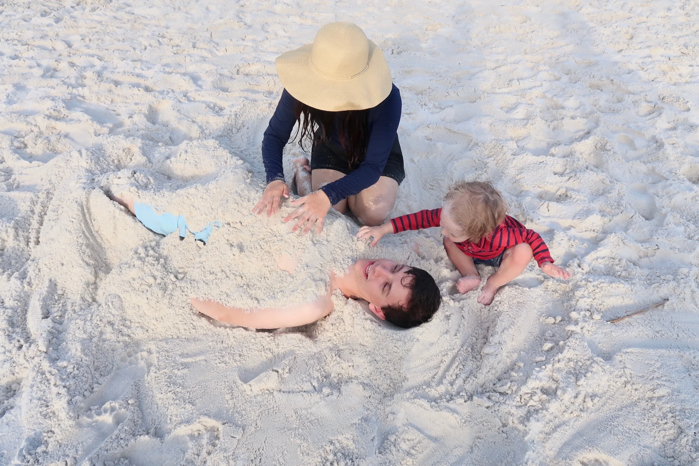 Patrick and Flora burying our brother Joseph (or as the kids call him - Merlin) in the sand.