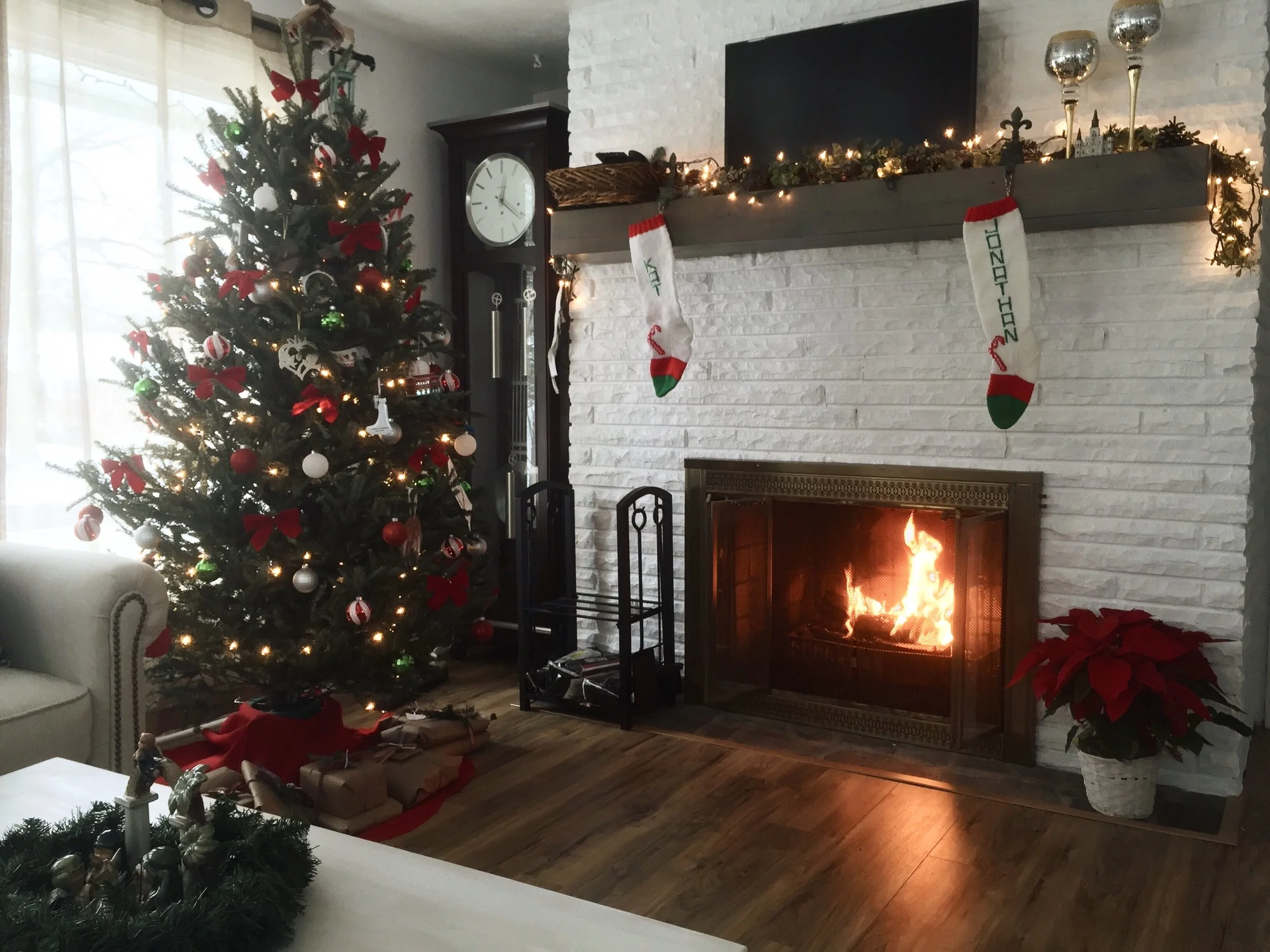 This is our fireplace. In our last minute nesting frenzy, we painted the whole fireplace from it's original grey and beige stone to white and added this mantel from Wayfair. Haven't looked back once.