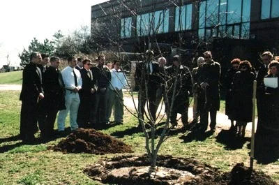 A tree dedication ceremony held at Bryant in memory of Professor Pedro Beade, The tree was donated by the Delta Chi Fraternity.