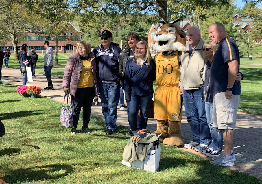 One family poses with Boomer the Bobcat on the quad.