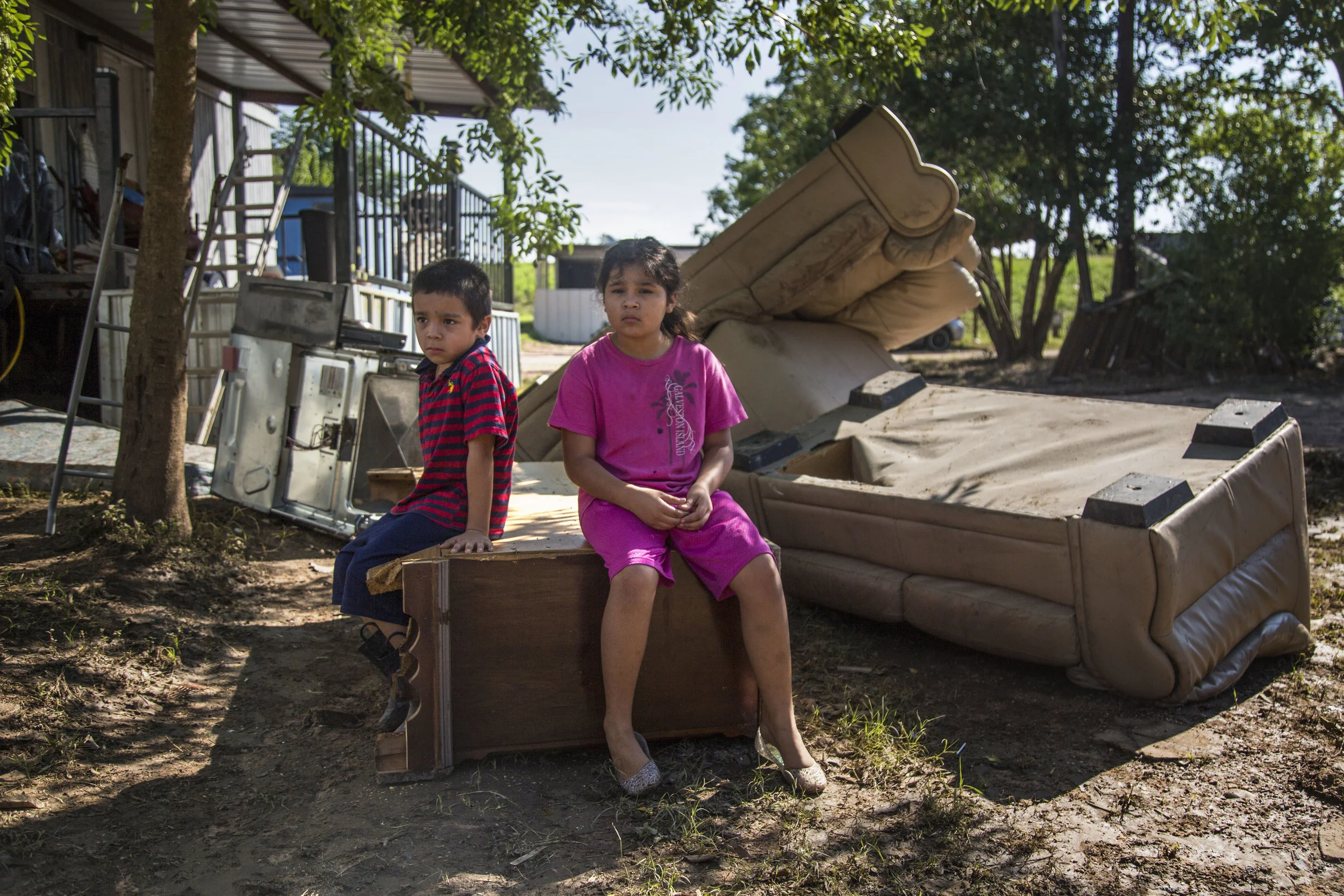  On Aug. 30, 2017, Jose Rauda, 6, and his sister, Daniella Rauda, 8 sat on one of the sofas in the sun quietly observing the damage wreaked by Tropical Storm Harvey in their hometown, La Grange, TX. The children live in a trailer with their parents, 