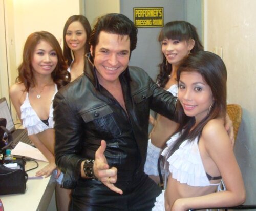 ETA Johnny Thompson poses with Filipino dancers in Manila.