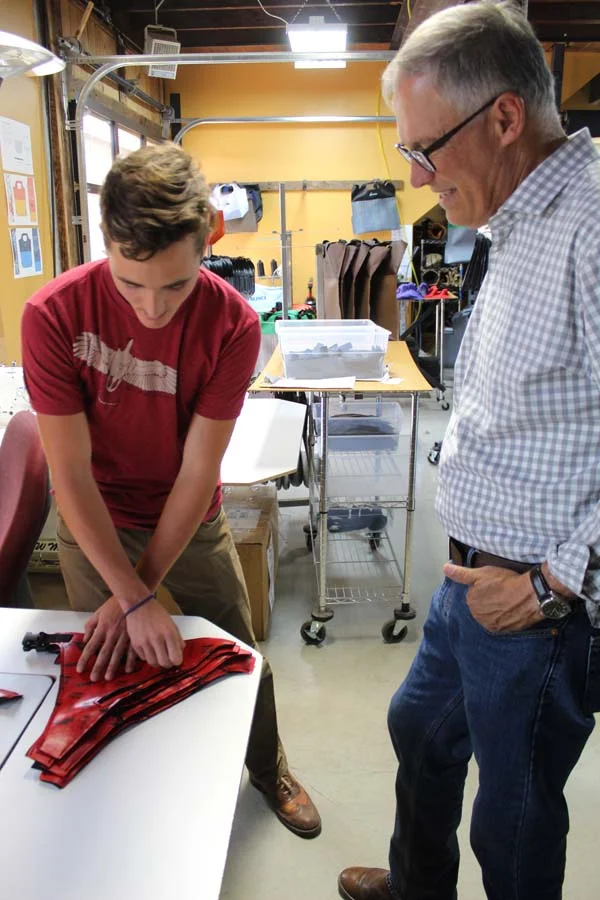 Photo by Don Nelson Recent Liberty Bell High School graduate Lazo Gitchos, left, demonstrated a new product to Gov. Jay Inslee at the eqpd building on the TwispWorks campus, where Gitchos is an intern.